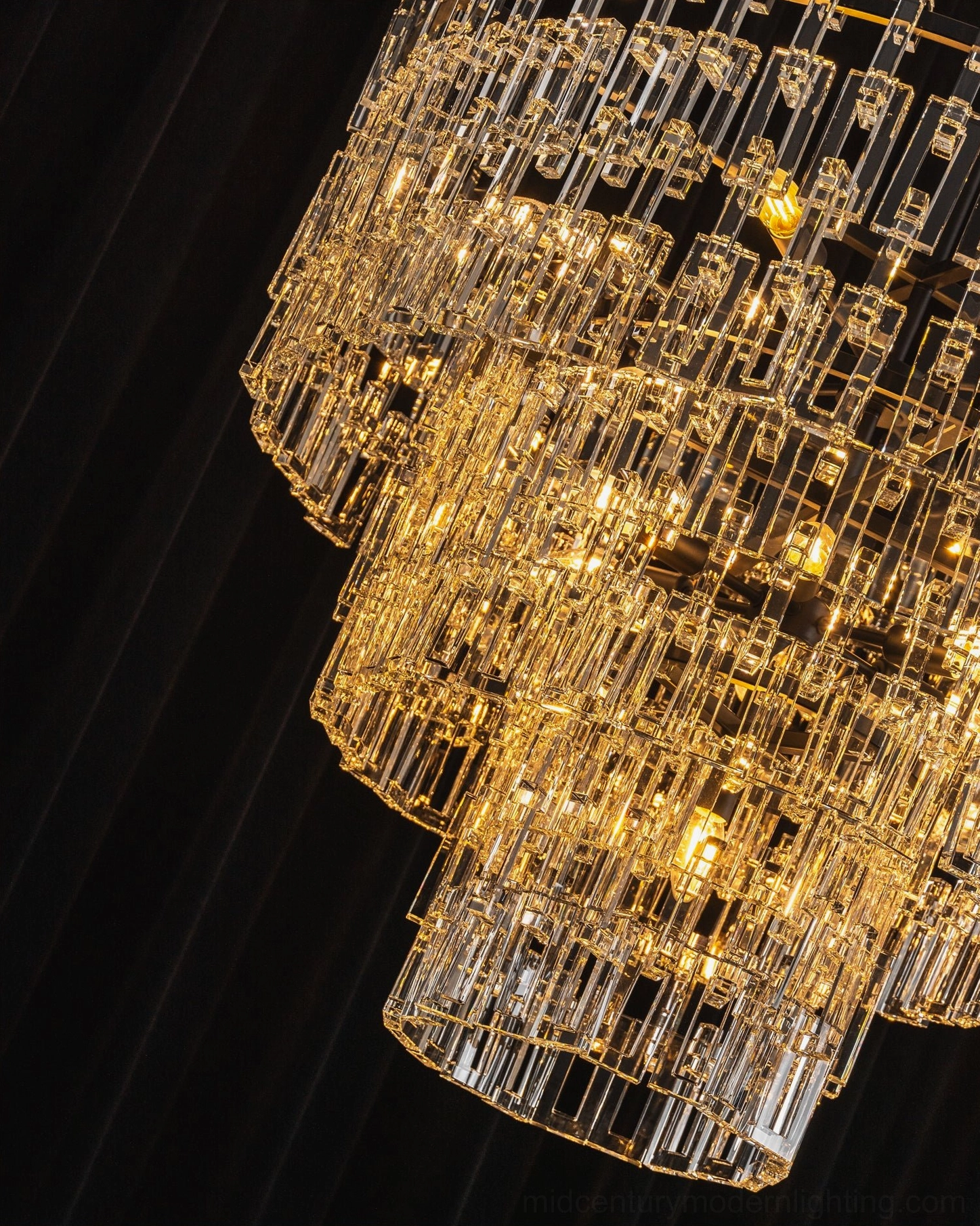 Harlow geometric crystal chandelier detail shot showing precision-cut crystal prisms and black metal armature