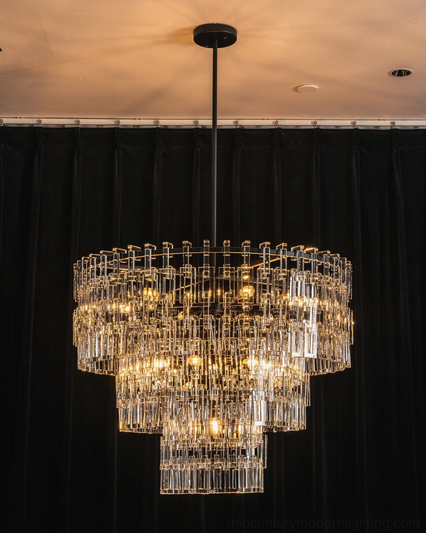 Tiered crystal chandelier waterfall composition showing geometric crystal arrangement and light transmission