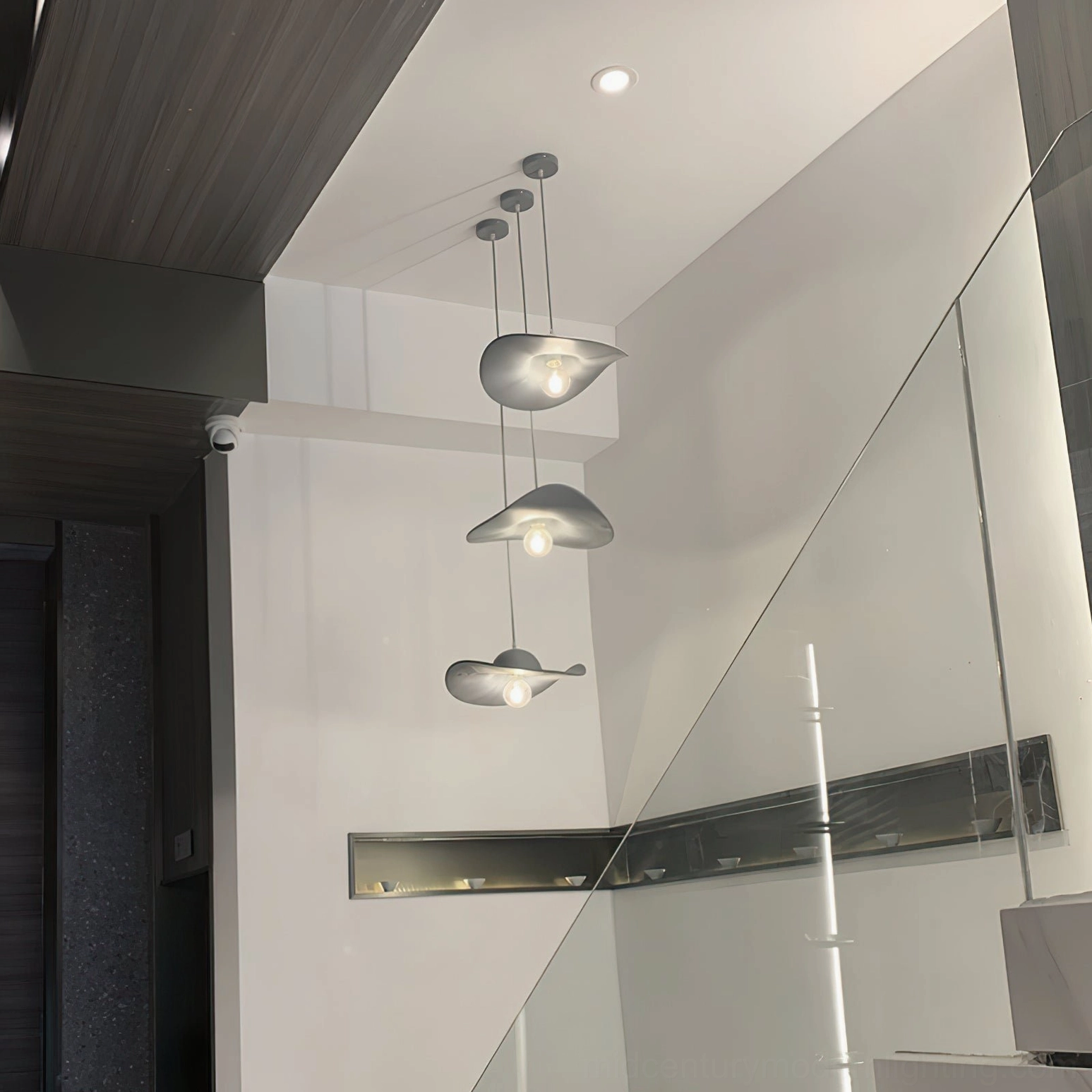 Hat-shaped ceiling pendant with exposed bulb creating warm ambient lighting