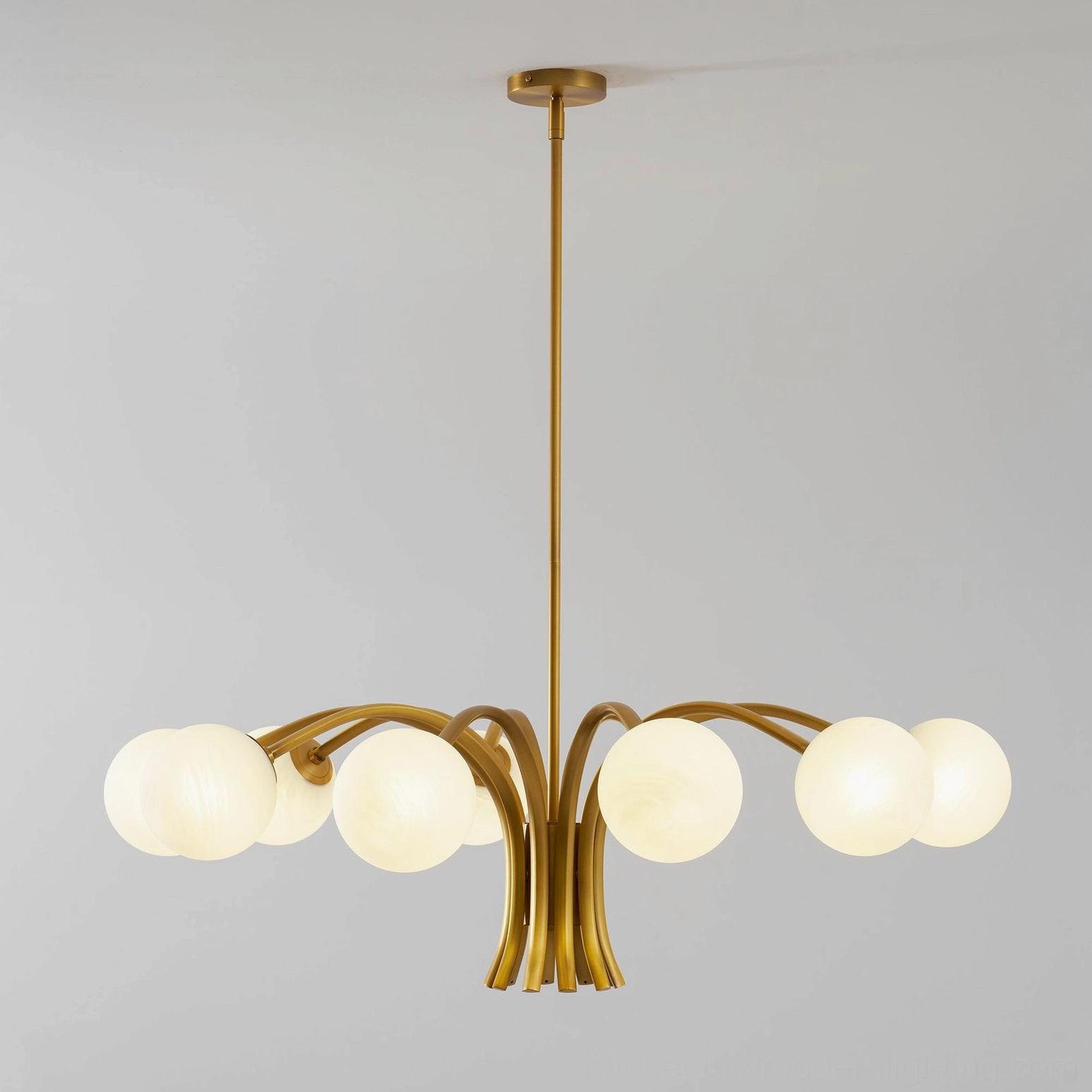 Brass globe chandelier for modern interiors, featuring sculptural design and ambient light diffusion