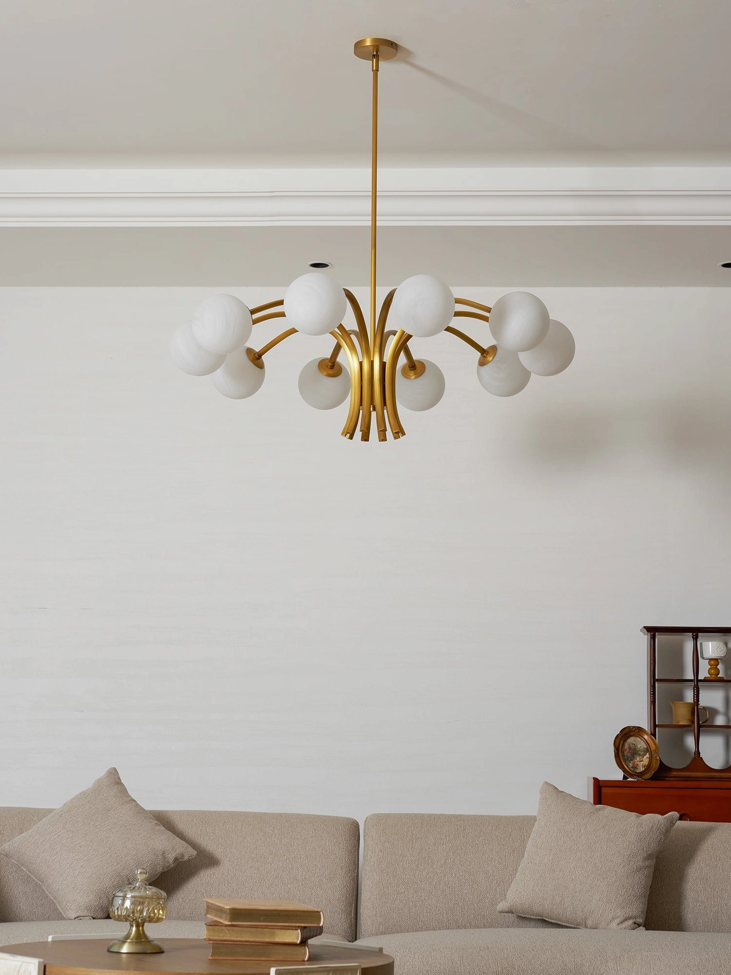 Polished brass chandelier with 10 frosted glass globe shades, mid-century design aesthetic