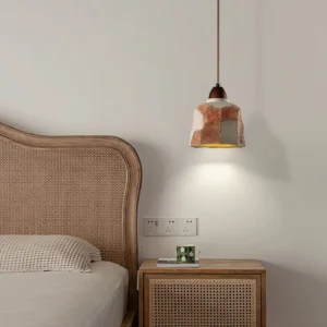 Havre pendant light installed in modern bedroom above bedside nightstand, warm rustic wabi-sabi style lighting