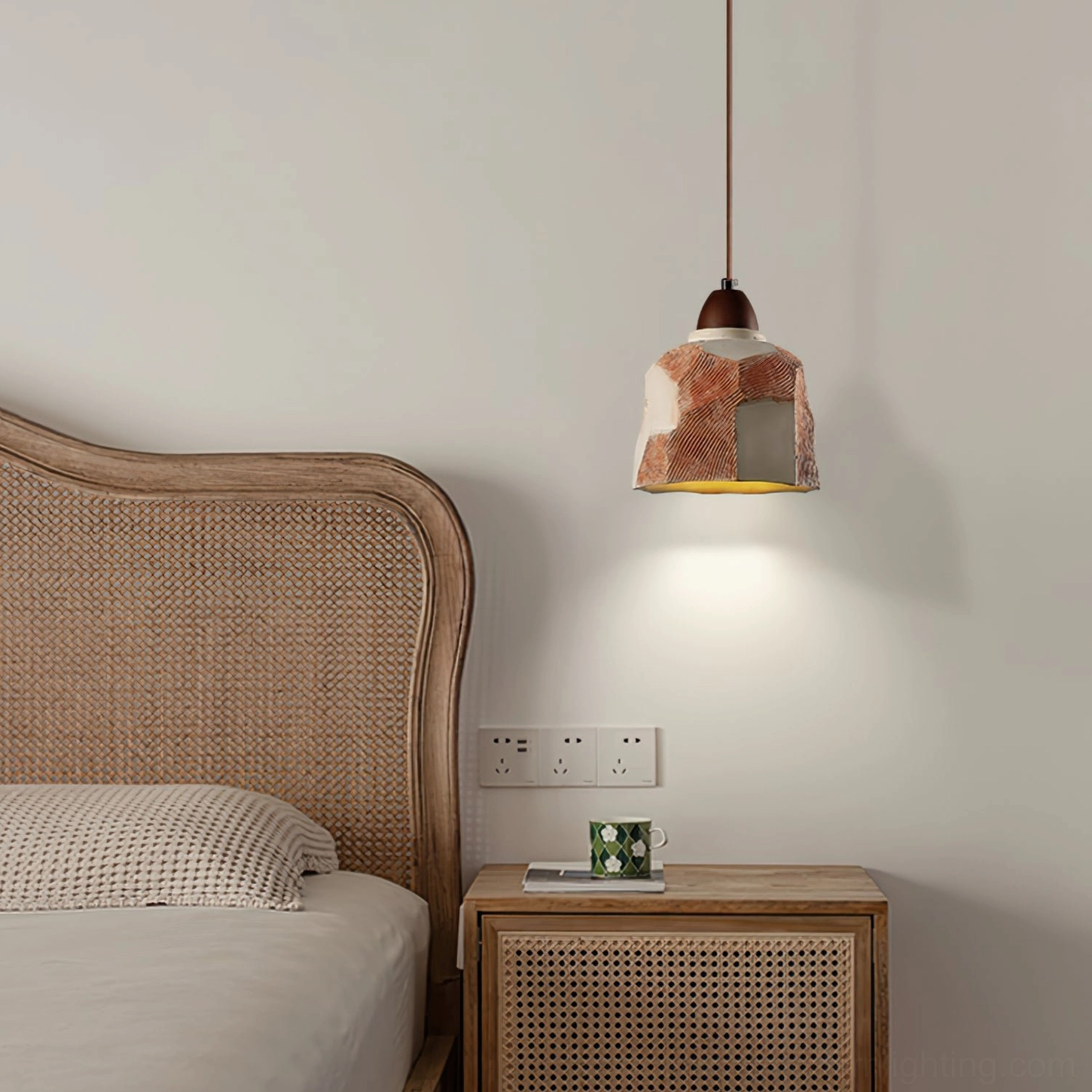Havre pendant light installed in modern bedroom above bedside nightstand, warm rustic wabi-sabi style lighting