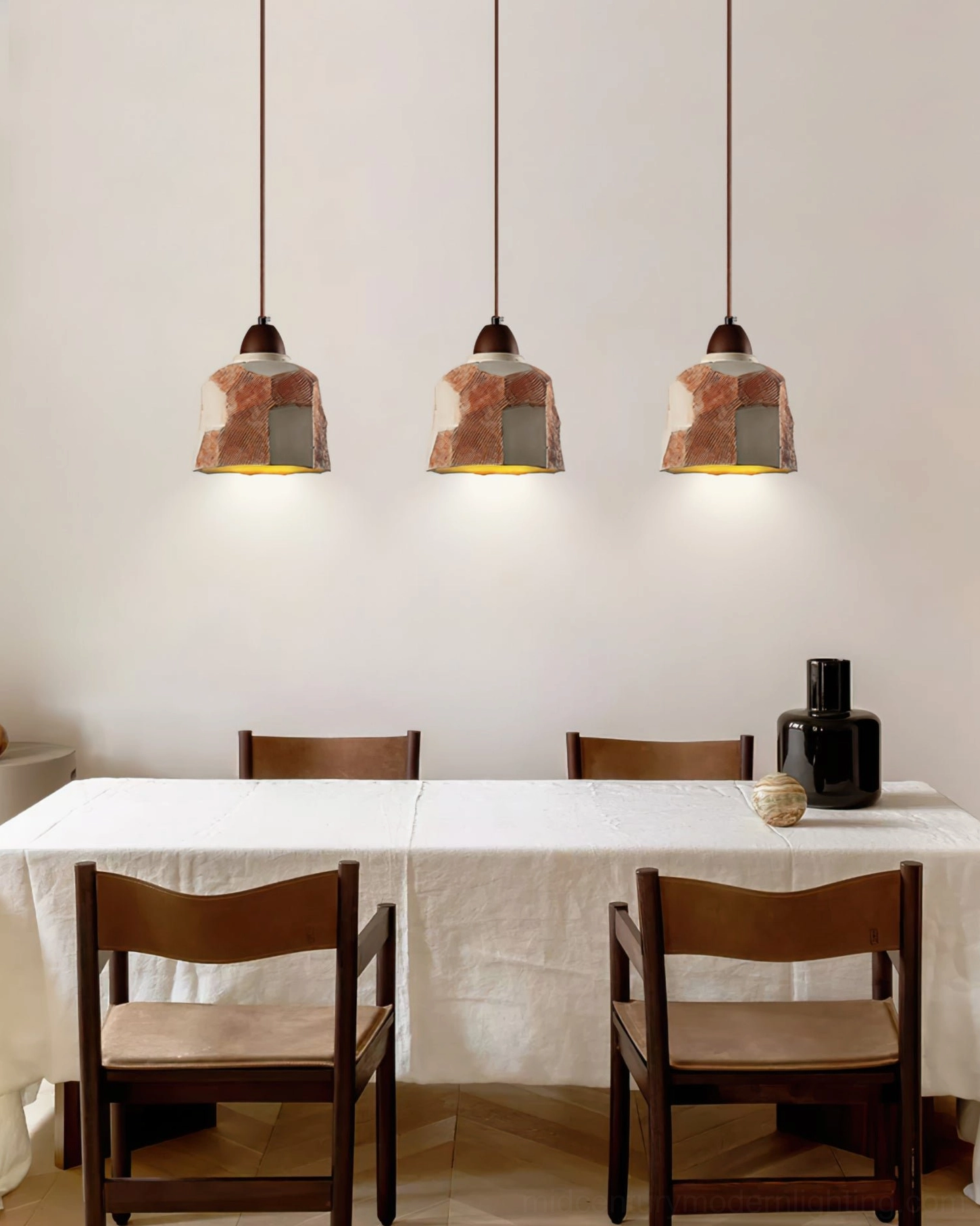 Multiple Havre pendant lights clustered above dining table with chairs, cozy rustic dining room ambiance