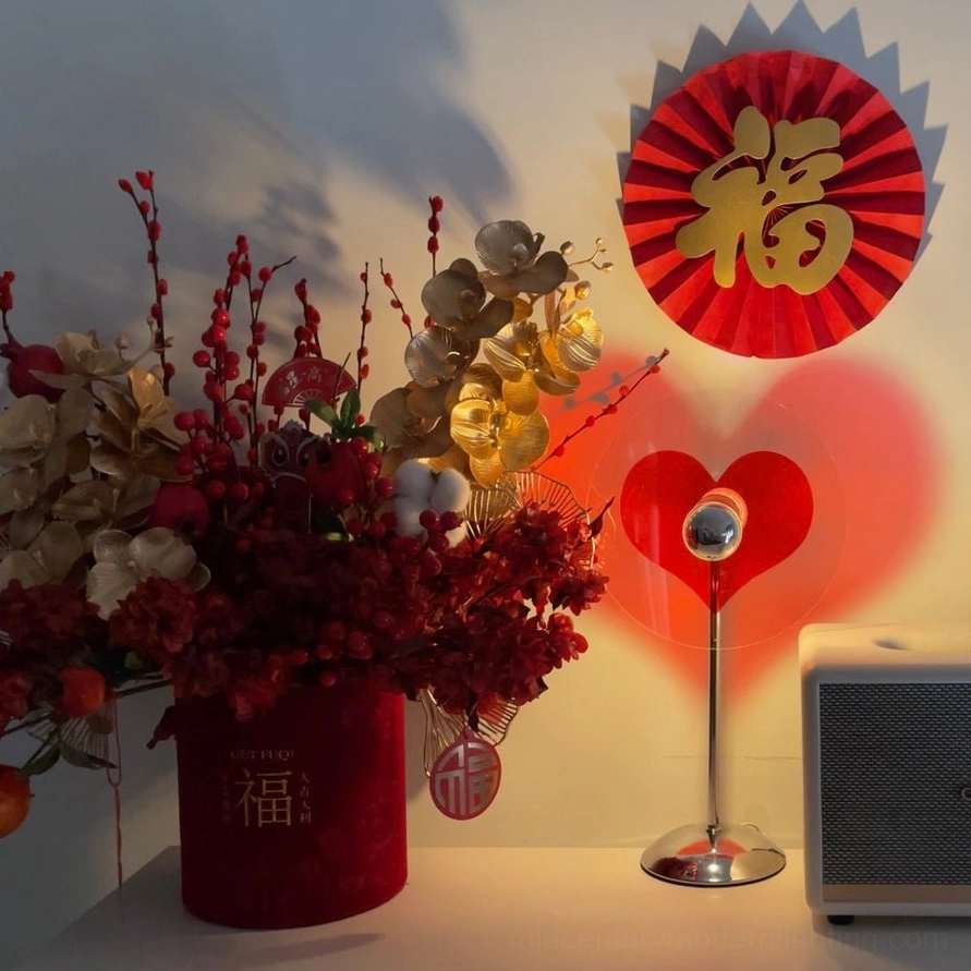 Heart projection lamp casting glowing red heart on wall surface, ambient decoration effect