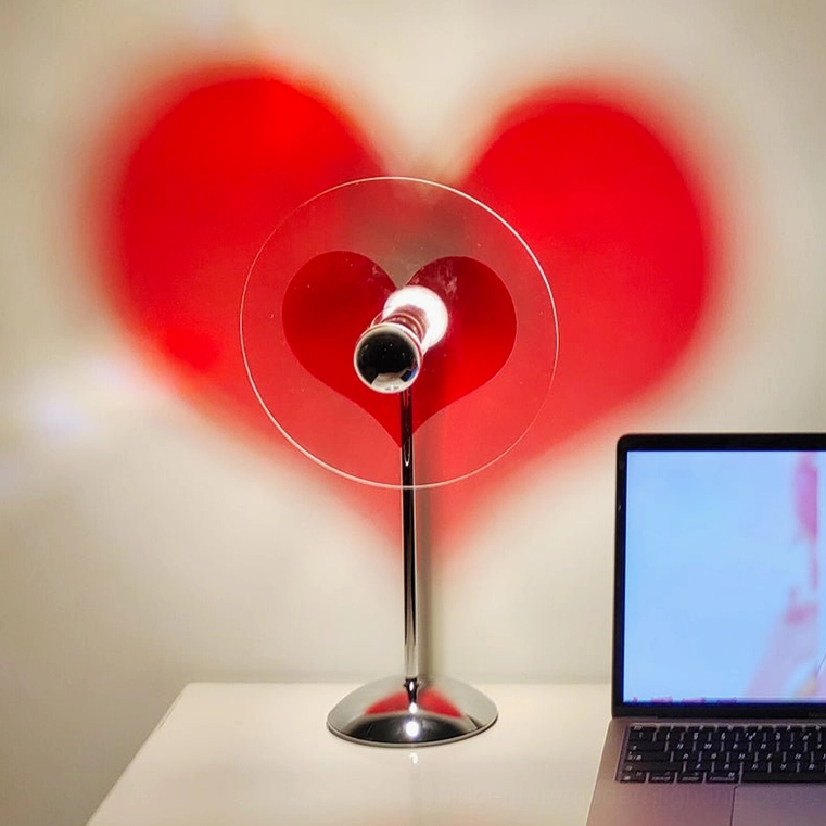 Heart projection table lamp creating intimate ambient lighting in personal room space