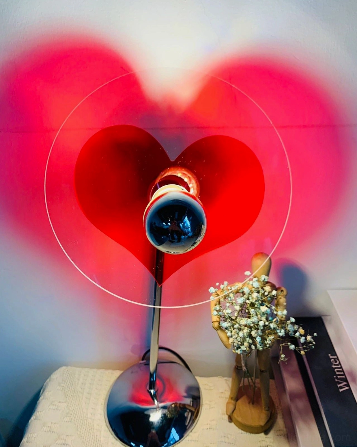 Heart projection lamp in home office creating personalized atmosphere and professional aesthetic blend