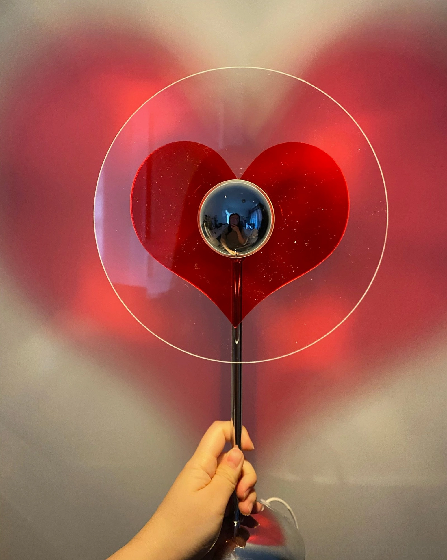 Heart projection lamp providing warm counterpoint to cold architectural elements in modern design spaces