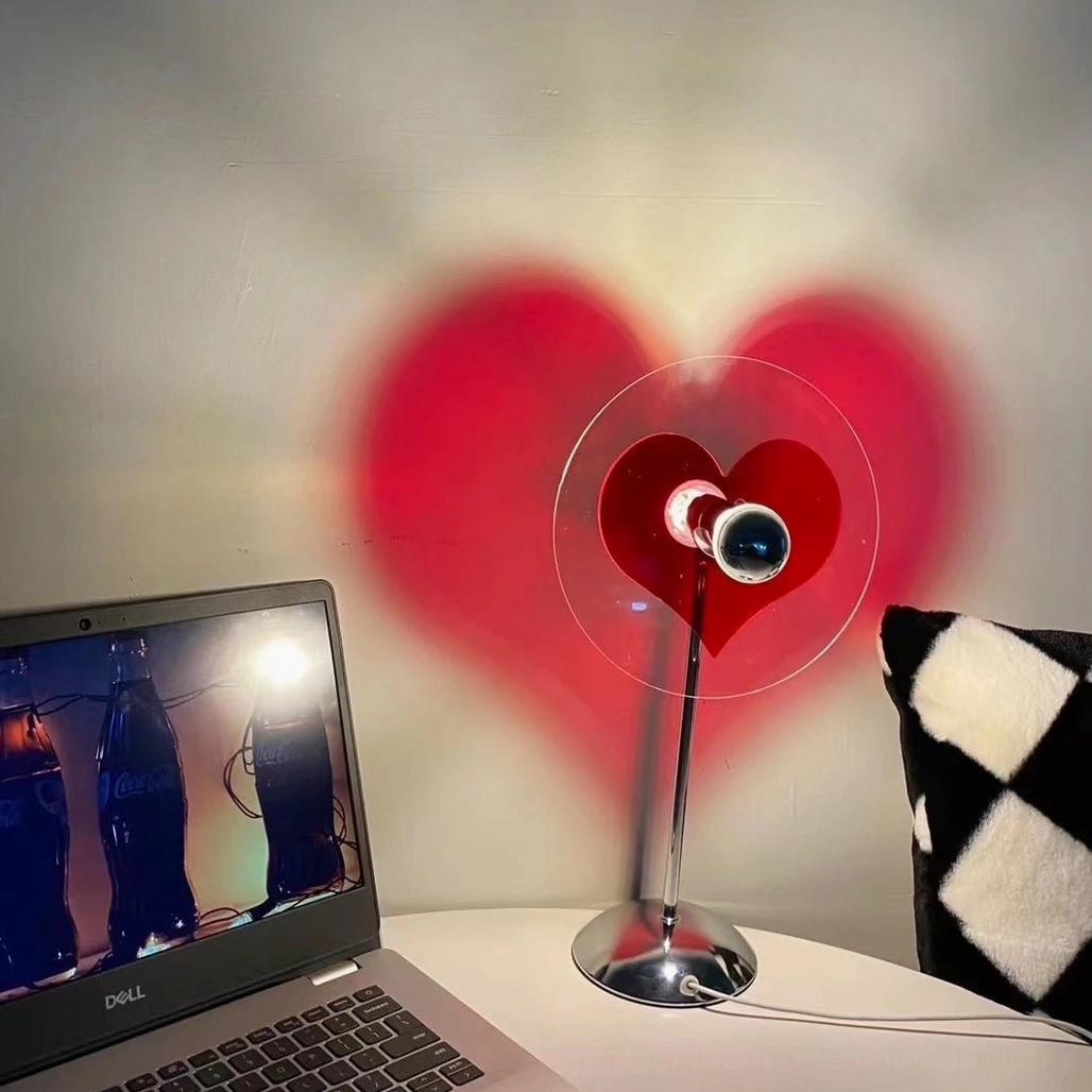 Heart-shaped LED lamp as ambient illumination without direct screen glare for creative desk workspaces