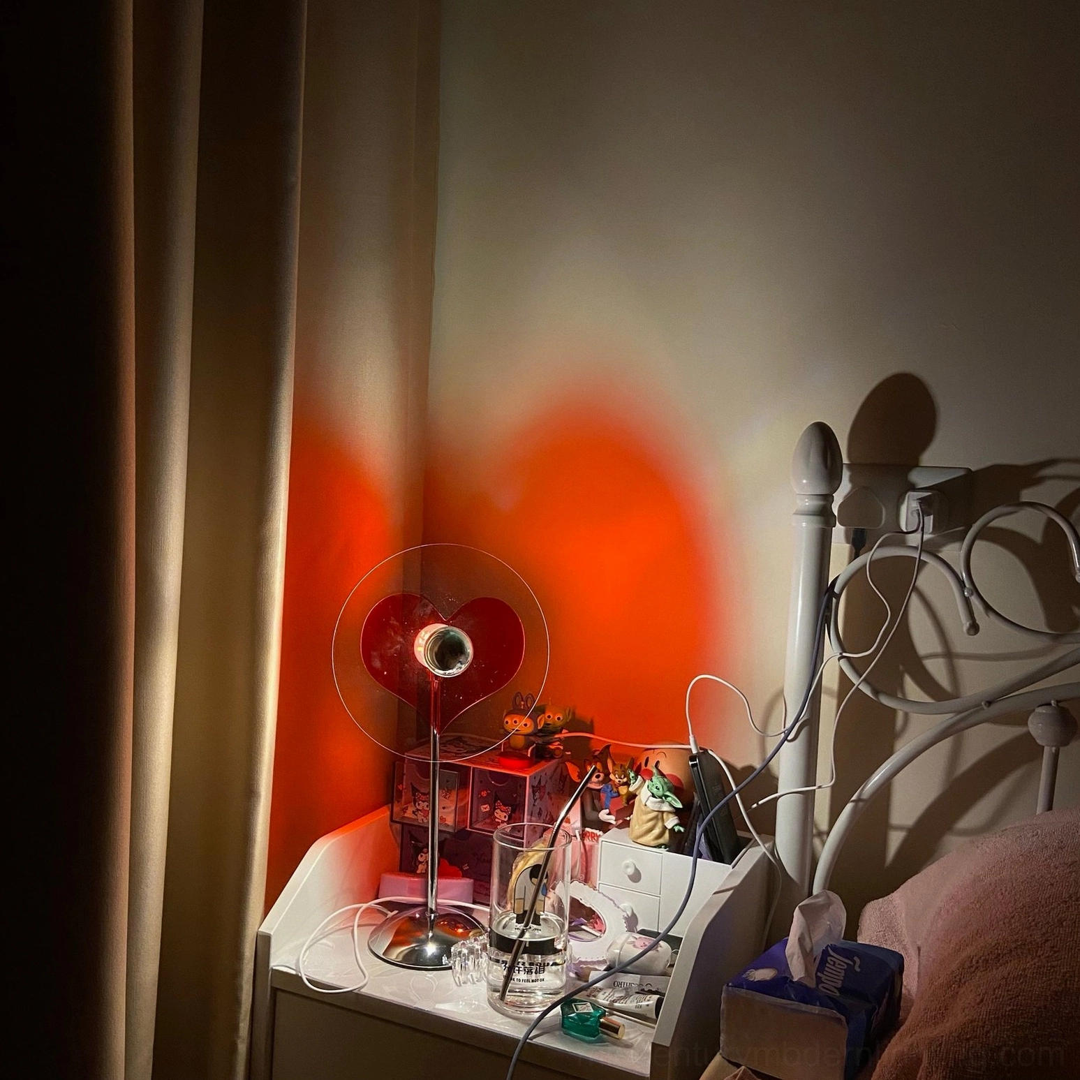 Heart-shaped lamp with chrome finish from side angle, showing structural design and proportions