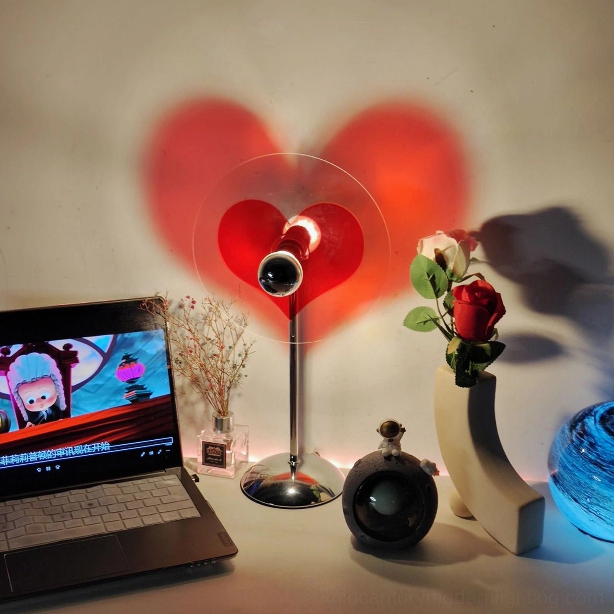 Heart-shaped lamp detail showing LED light source and projection mechanism within acrylic shade
