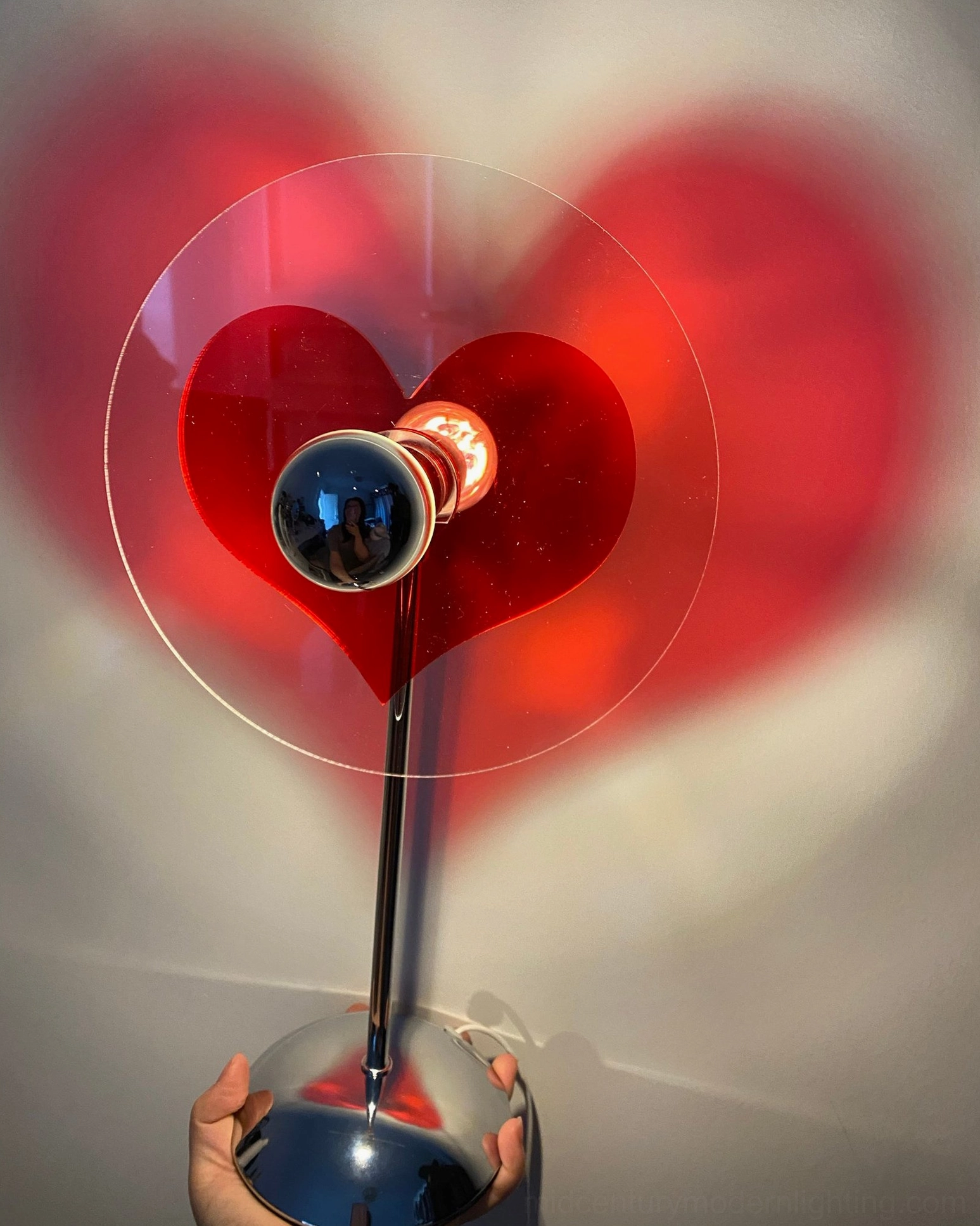 Heart-shaped LED lamp adding personality and warmth to creative office and workspace environments daily