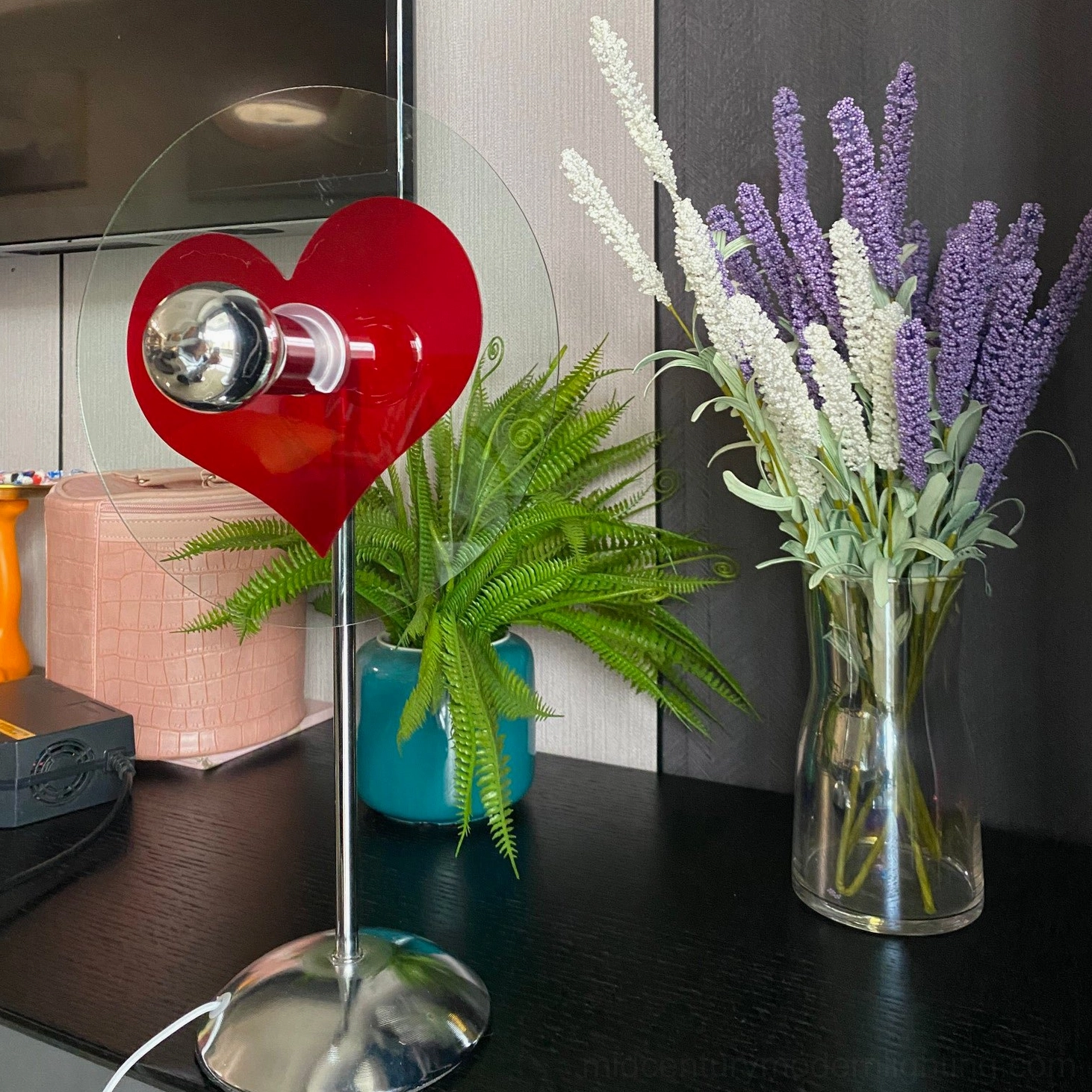 Heart-shaped table lamp demonstrating red heart projection effect in home environment