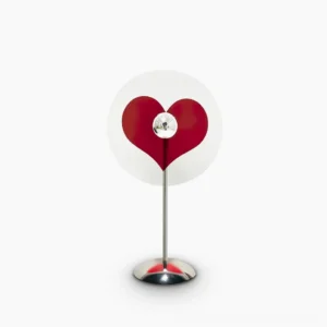 Heart-shaped red LED projection table lamp on white background, minimalist modern design with chrome metal frame and clear acrylic base