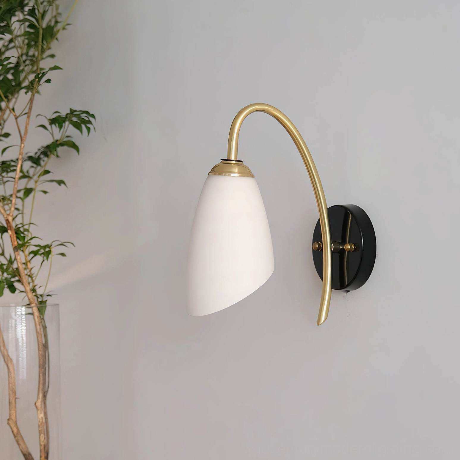 Hector modern wall sconce in corner interior setting with potted plant accent