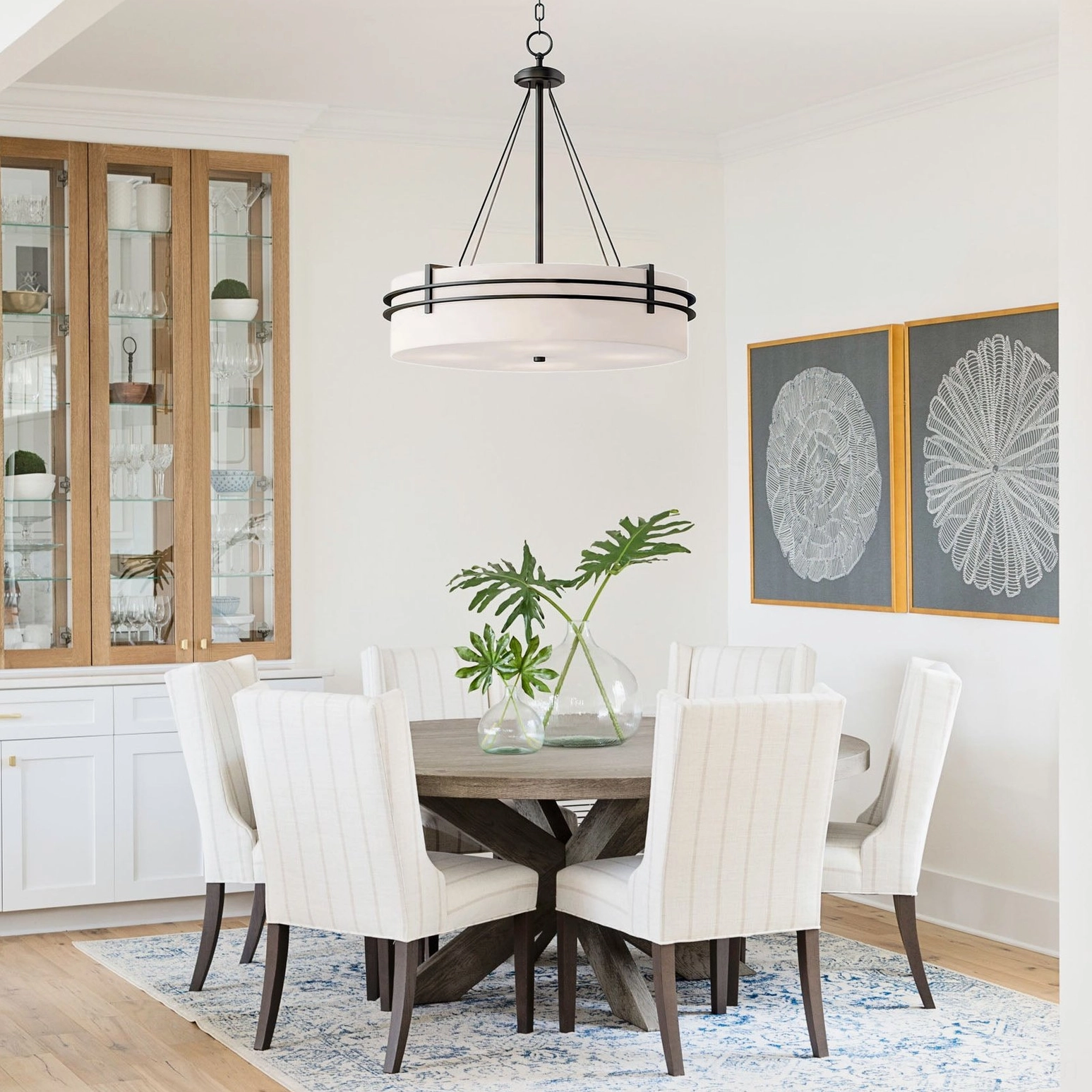 Heddle pendant chandelier in formal dining room setting above traditional wooden dining table