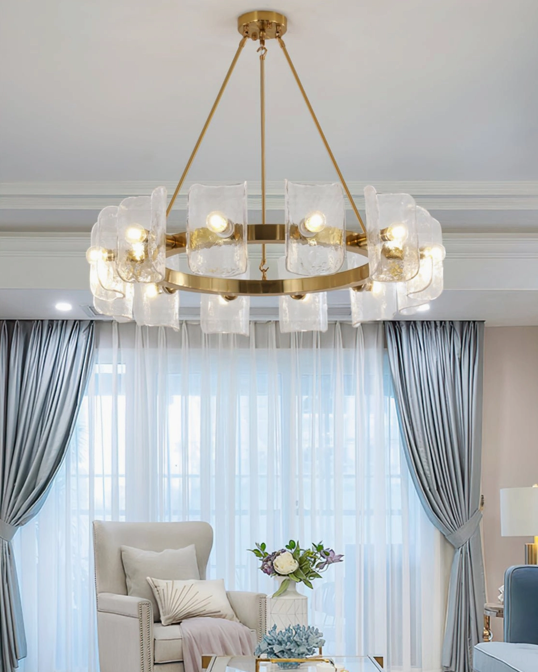 Helios mid-century modern chandelier illuminated in bright contemporary living room with gray blue curtains