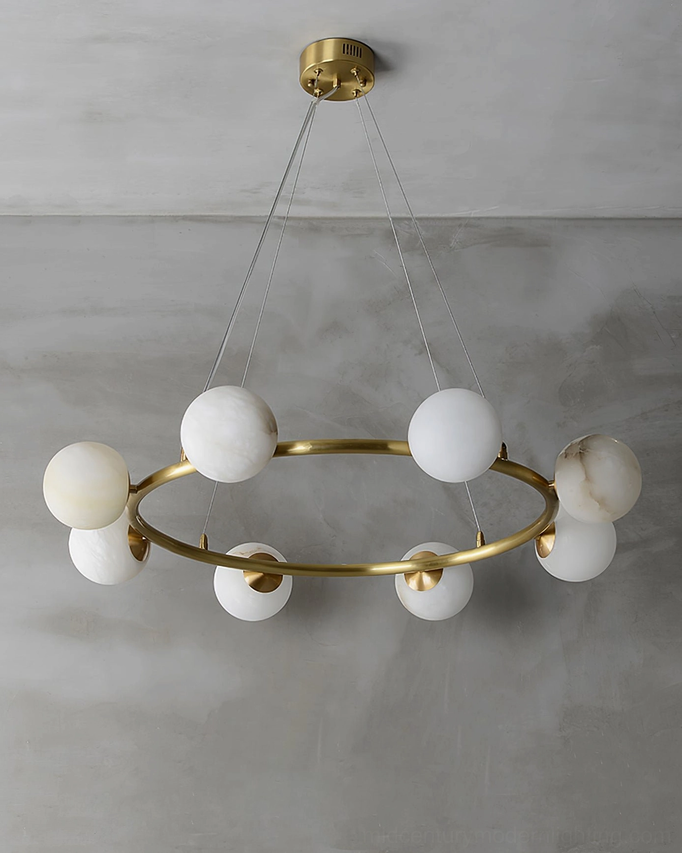 Helix modern ring chandelier with symmetrical alabaster lamp arrangement and brushed brass hardware, overhead view gray wall