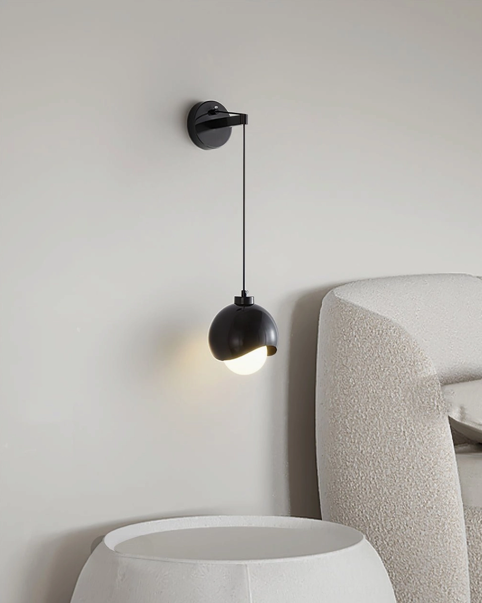 Helmet wall lamp black spherical shade modern living space accent chair interior design