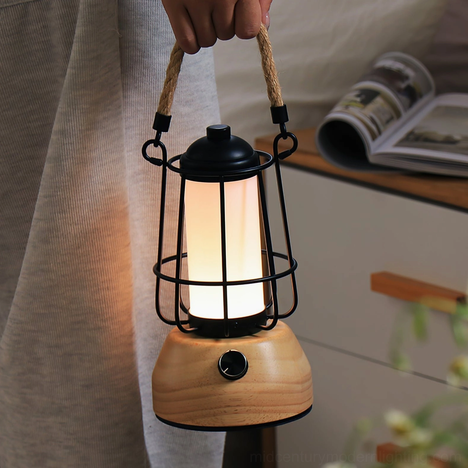 Hand holding portable hemp rope lantern battery-powered table lamp demonstrating wireless convenience and portability