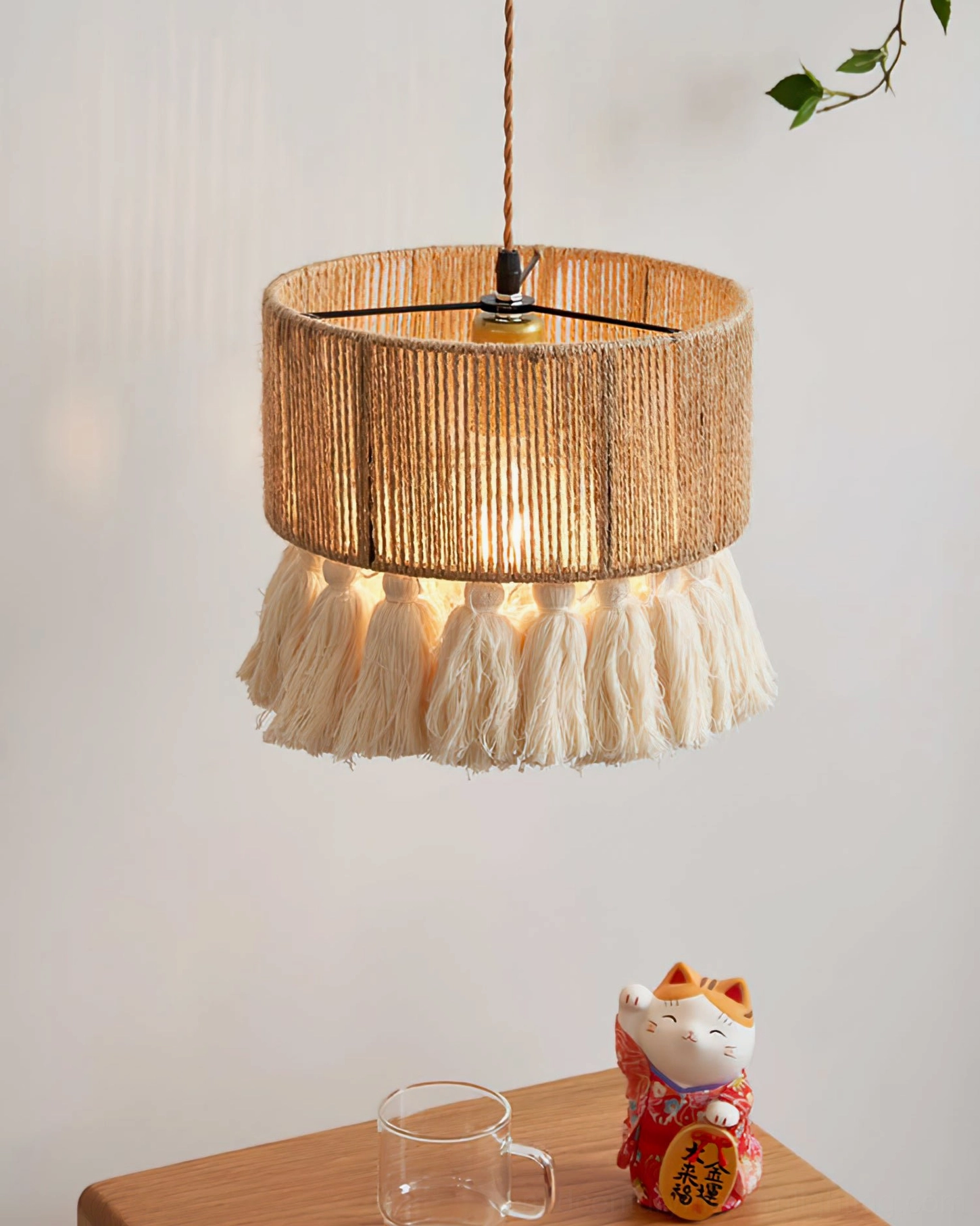 Handwoven hemp rope pendant lamp with cotton tassels detail, close-up showing intricate weave pattern and tassel trim