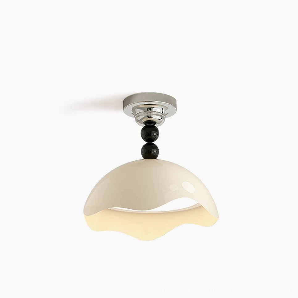 Henry ceiling lamp product shot showcasing the complete sculptural form, wavy edges, and minimalist cream-and-black color scheme from elevated angle