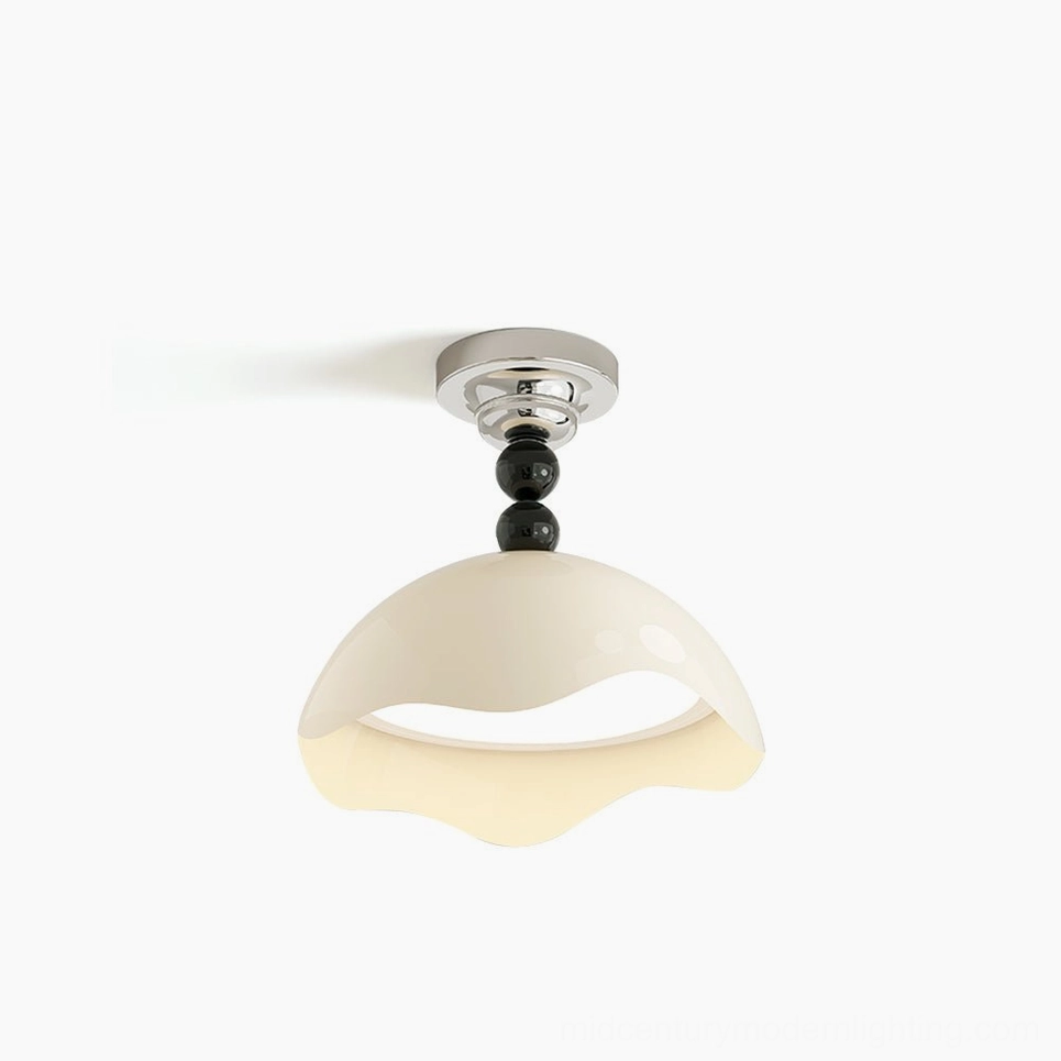 Henry wavy cream ceiling lamp with black accents, front three-quarter view showing sculptural shade design and modern minimalist aesthetics