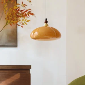 Herda pendant light hanging in vintage home interior with warm ambient lighting and wall artwork