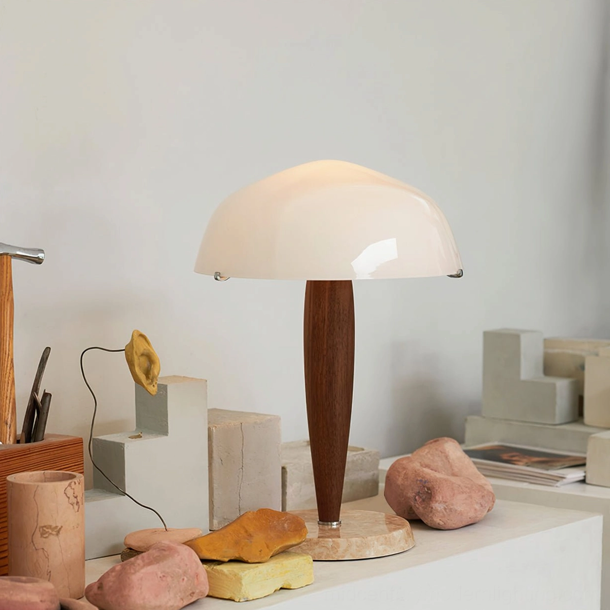 Herman minimalist marble base table lamp with domed acrylic shade, three-quarter angle on decorative craft display