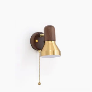 Heron mid-century modern wall sconce with brass shade and walnut wood base, front studio view