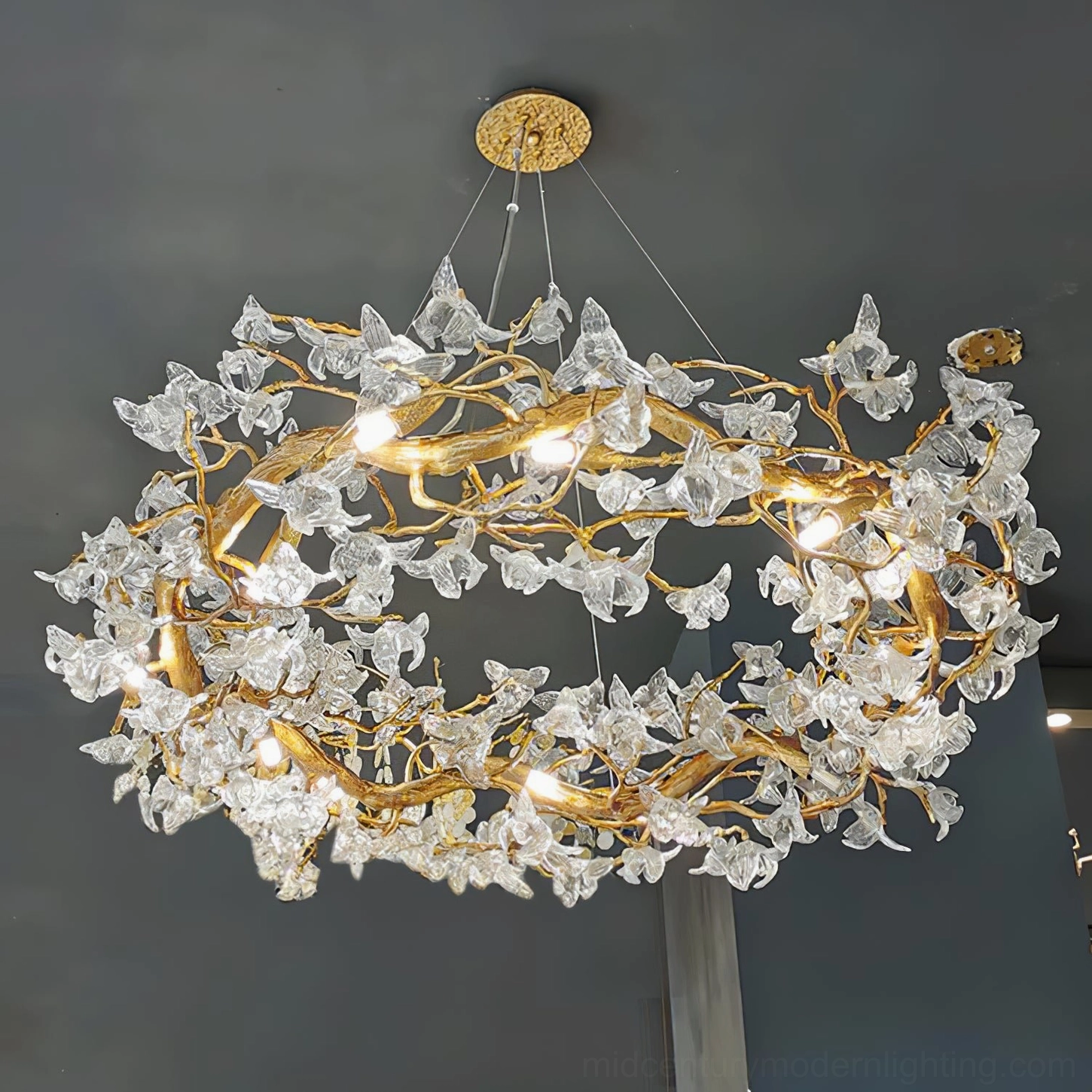 Hibiscus chandelier natural daylight showing realistic color of brass framework and crystal blooms