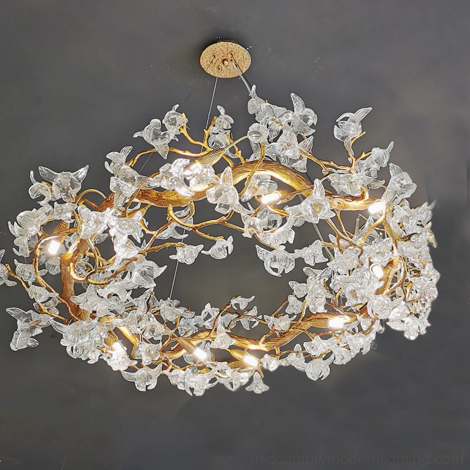 Side profile of hibiscus chandelier showing silhouette and brass branch structure