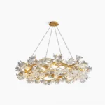 Hibiscus crystal chandelier with brass branches and clear flower petals overhead studio view on white background