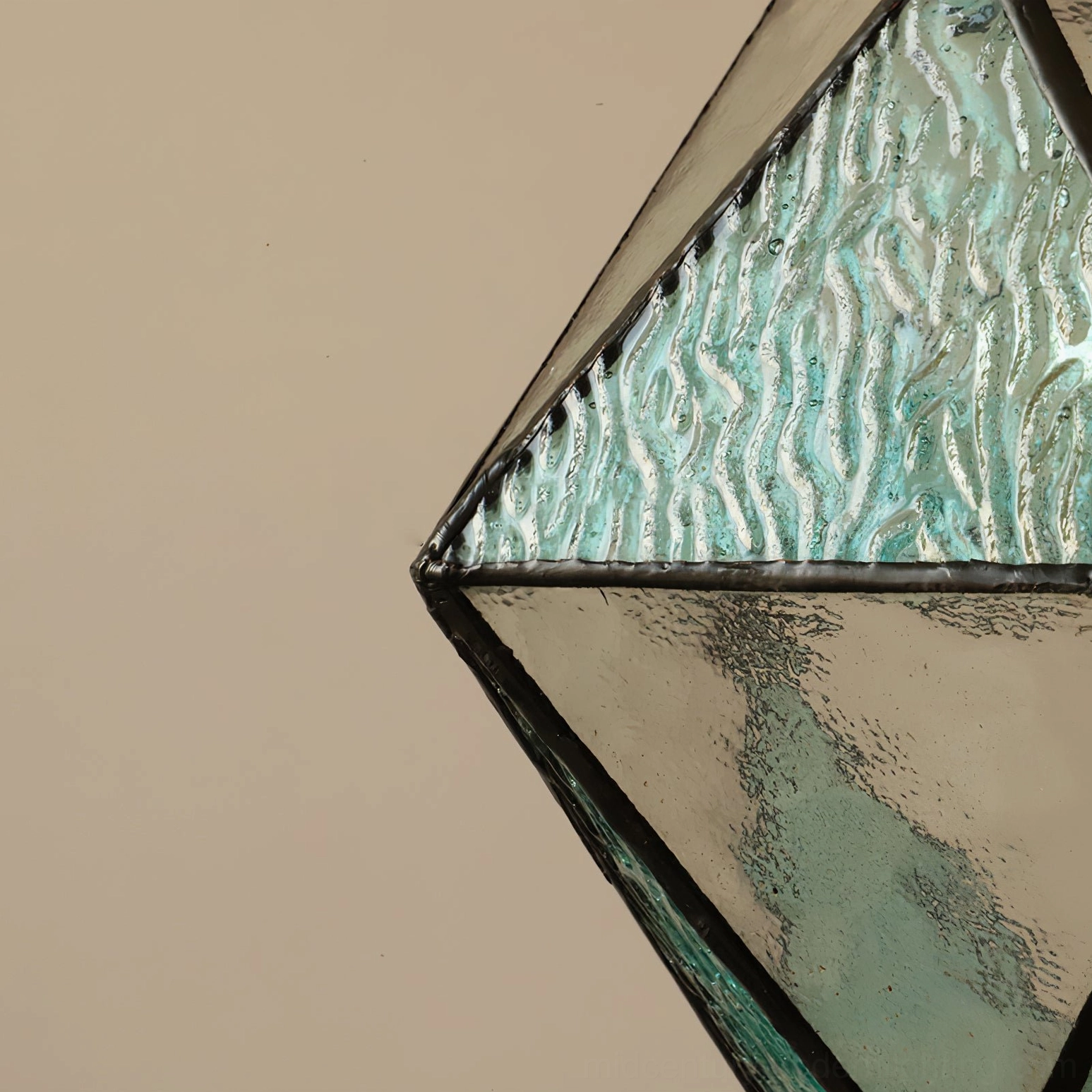 Hiro mint geometric glass panel extreme close-up detail shot, textured faceted surface pattern of hand-formed glass