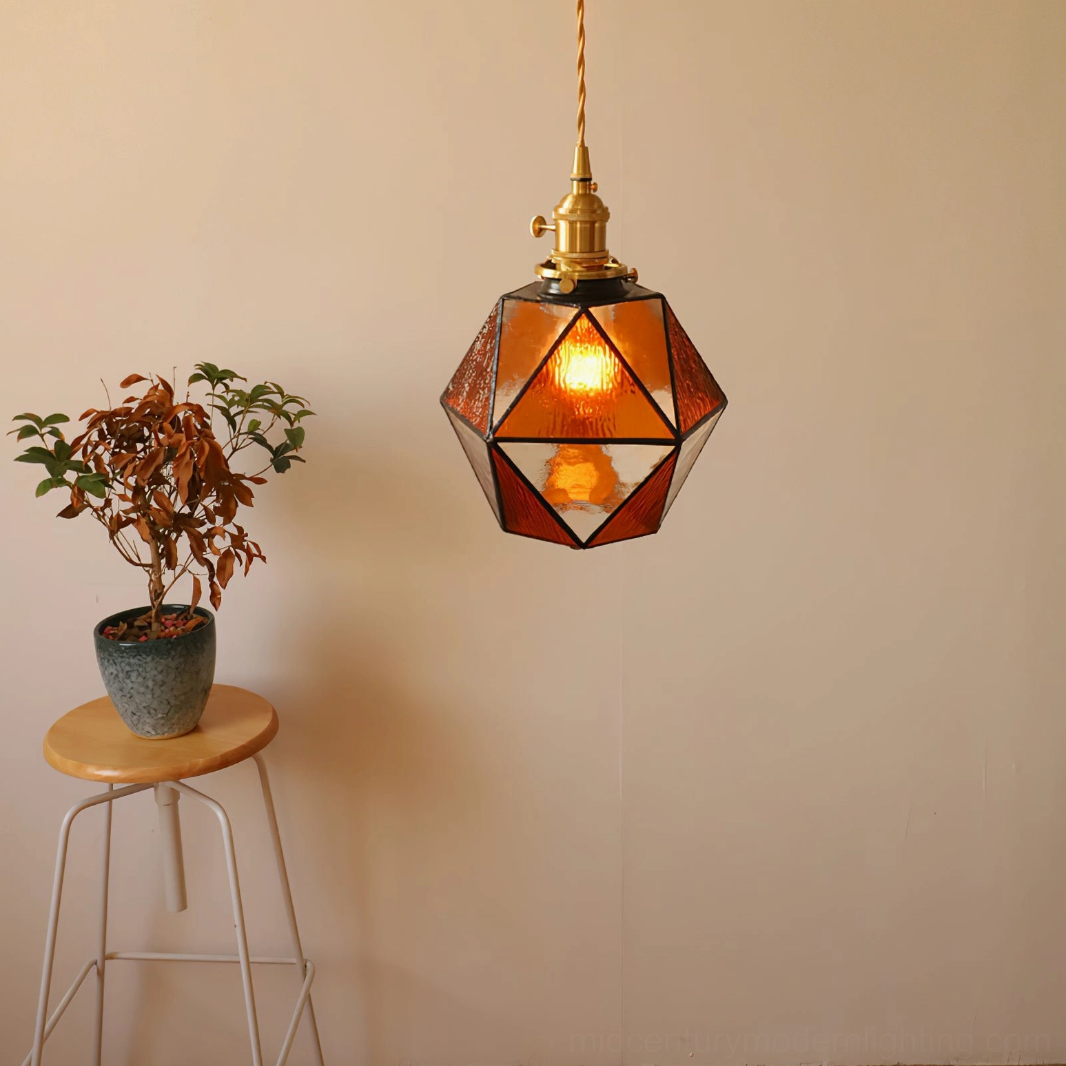 Hiro amber stained glass pendant lamp in bohemian home interior with small stool and potted plants, vintage aesthetic styling