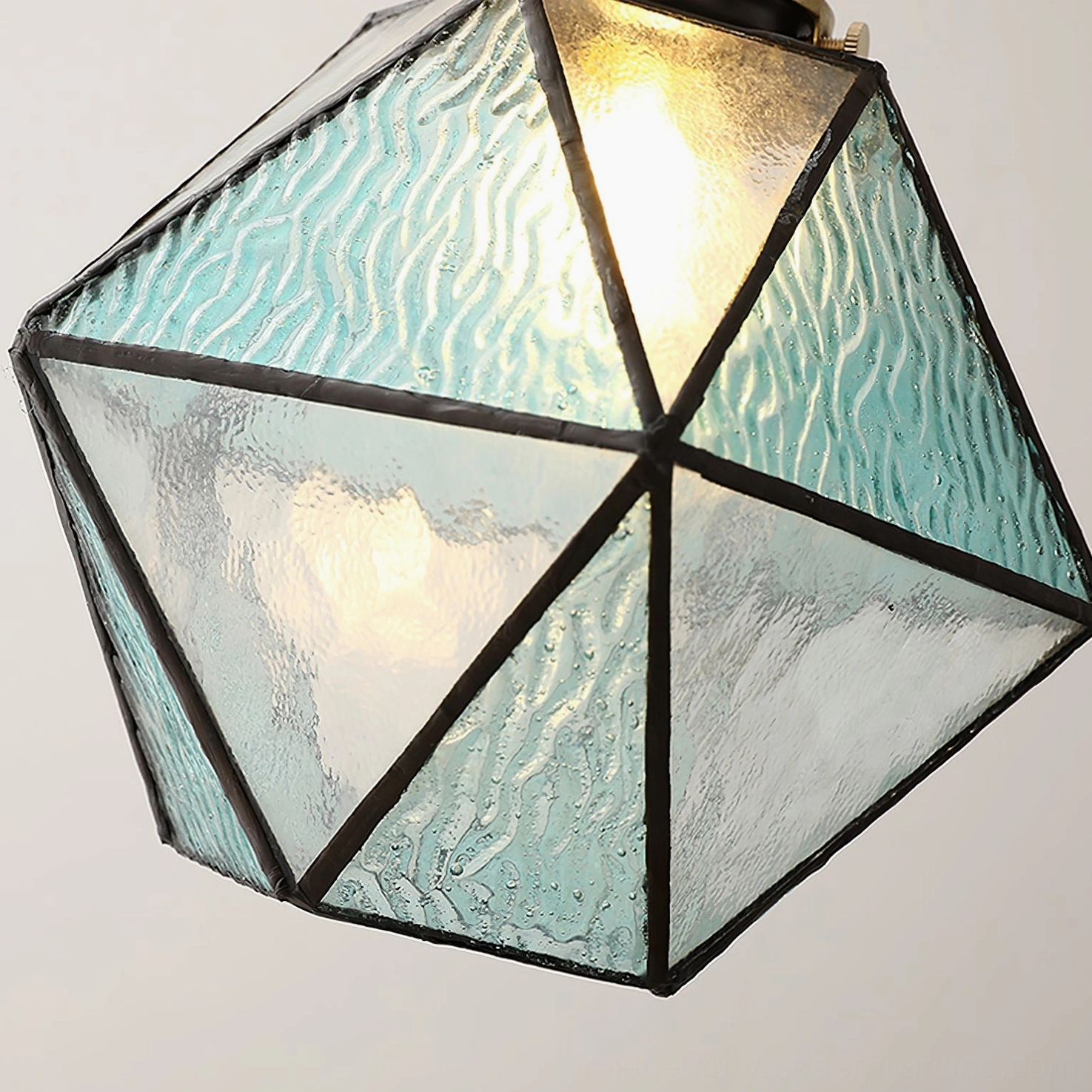Hiro mint rippled glass pendant lamp close-up with black trim and warm internal LED lighting, low angle detail shot