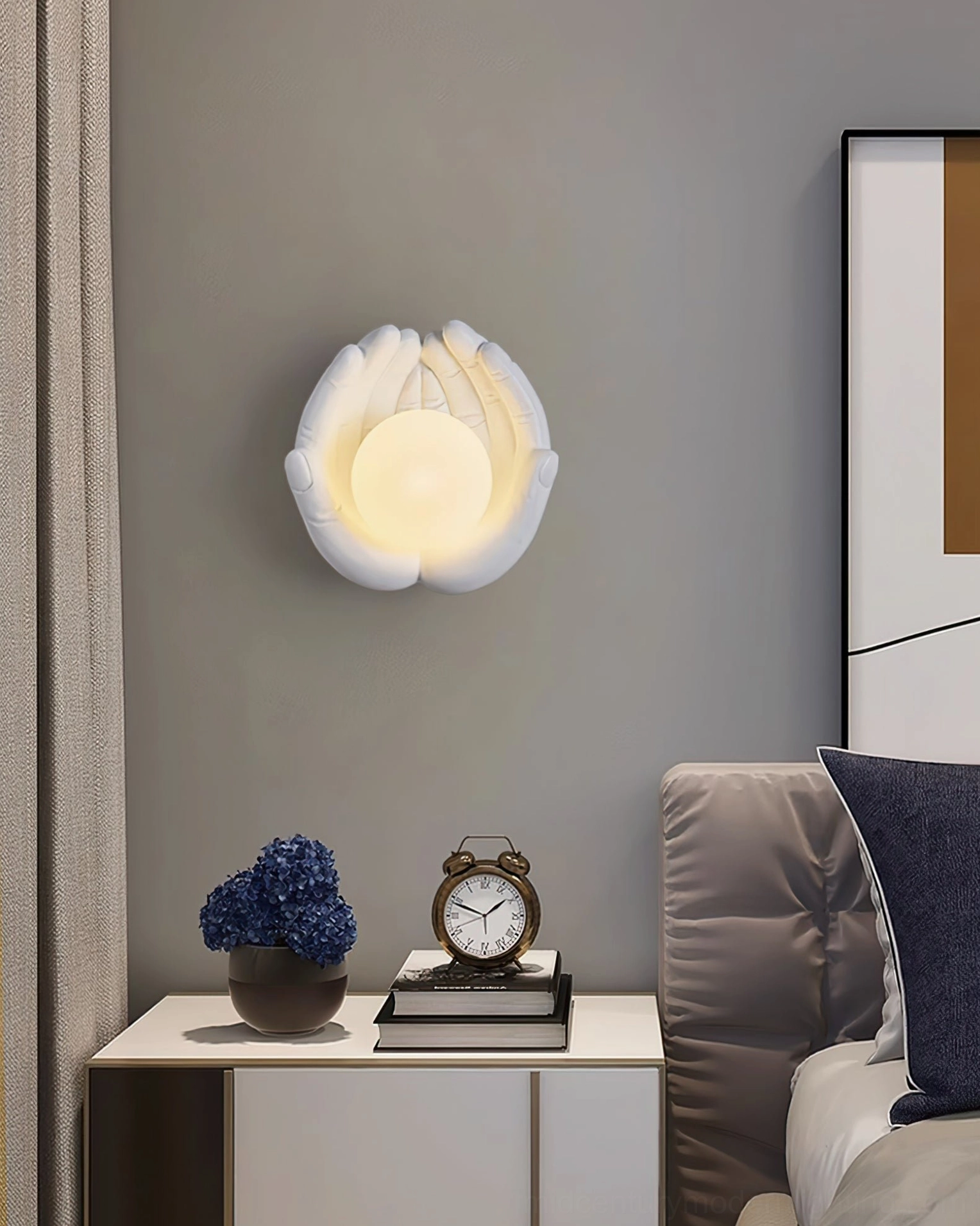 Matte white holding hands wall lamp positioned above bedroom nightstand, minimalist bedroom interior with warm ambient lighting