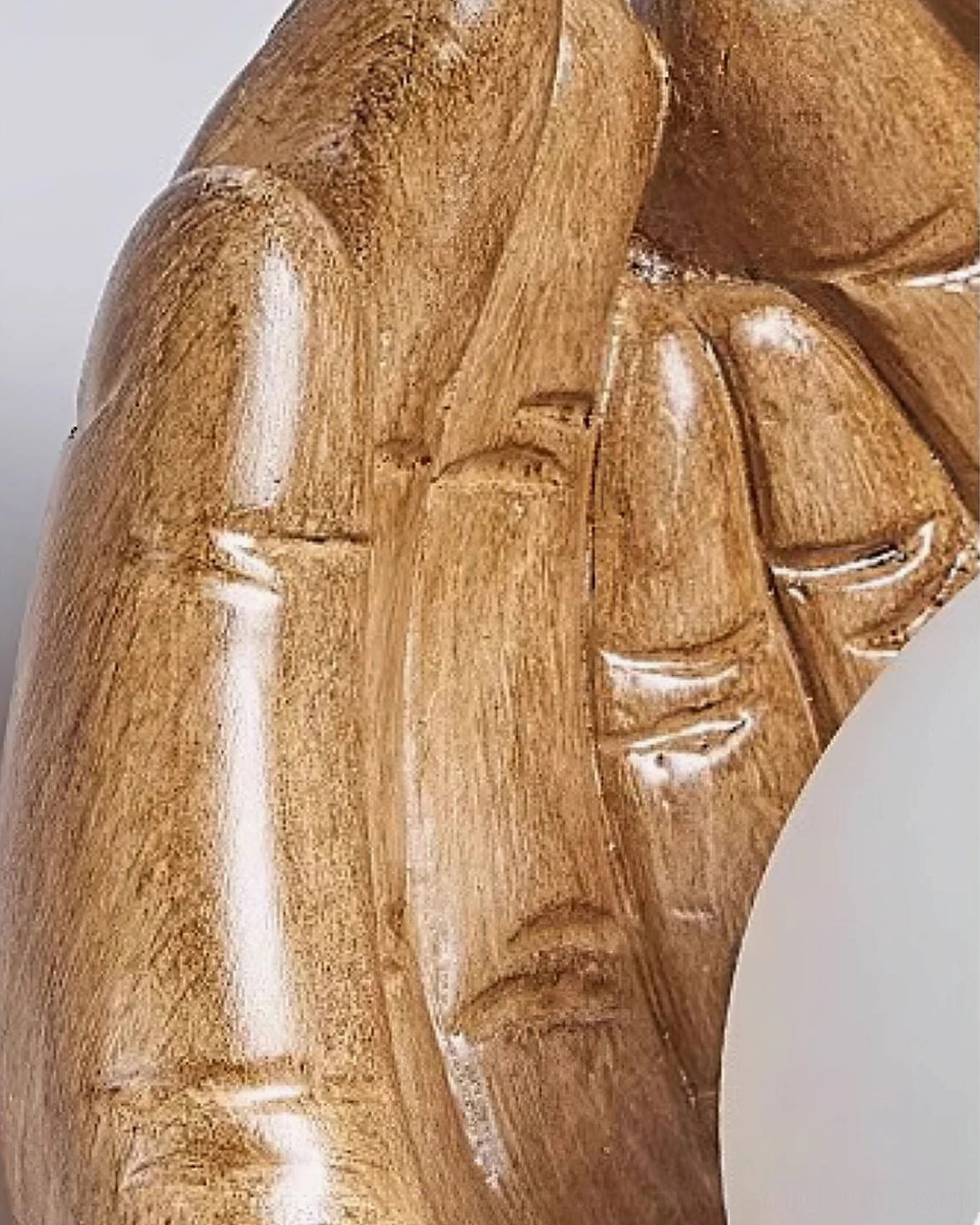 Side extreme close-up revealing realistic wood grain texture and anatomical precision of hand-crafted resin wall lamp