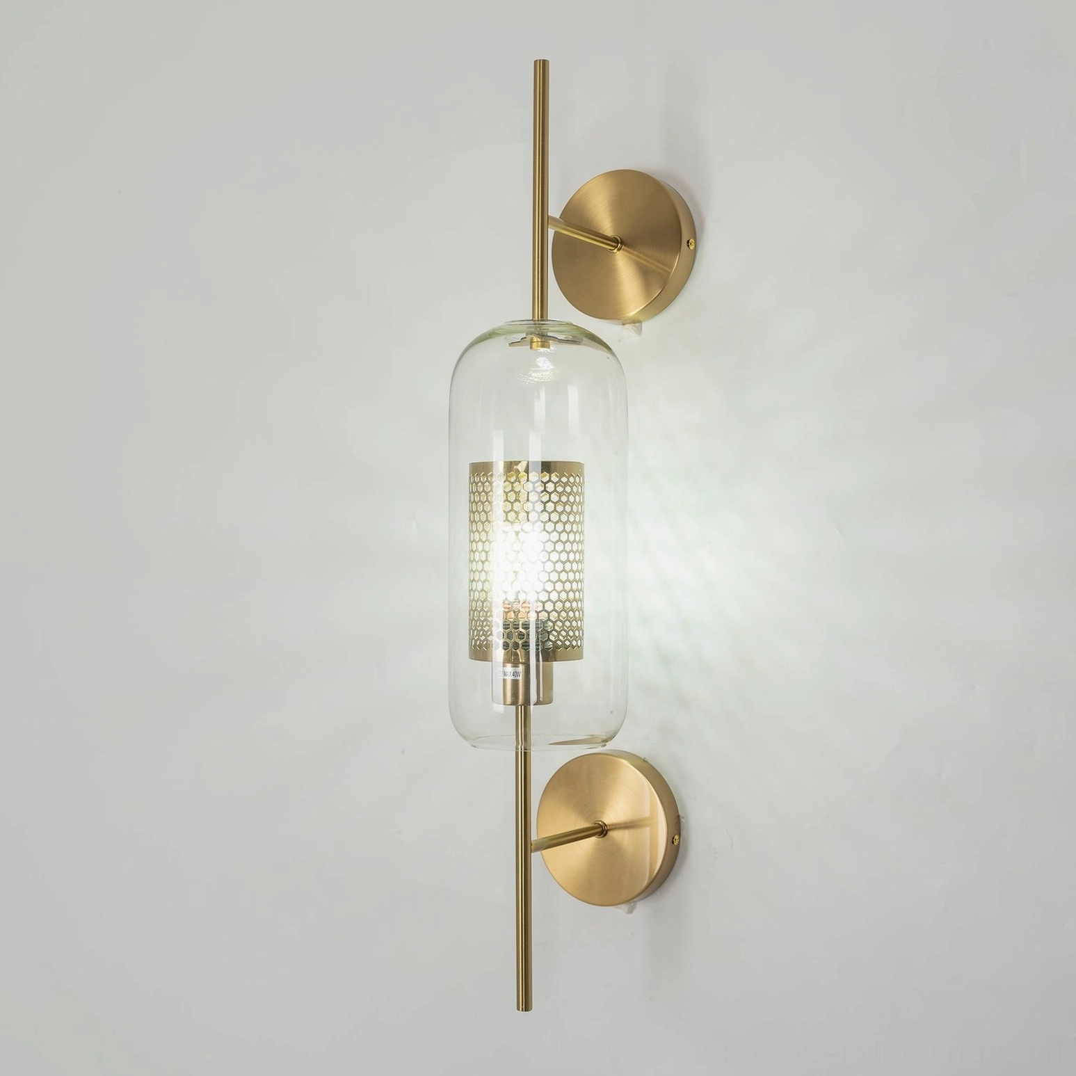 Honeycomb glass sconce with warm amber tone showing color and glass quality