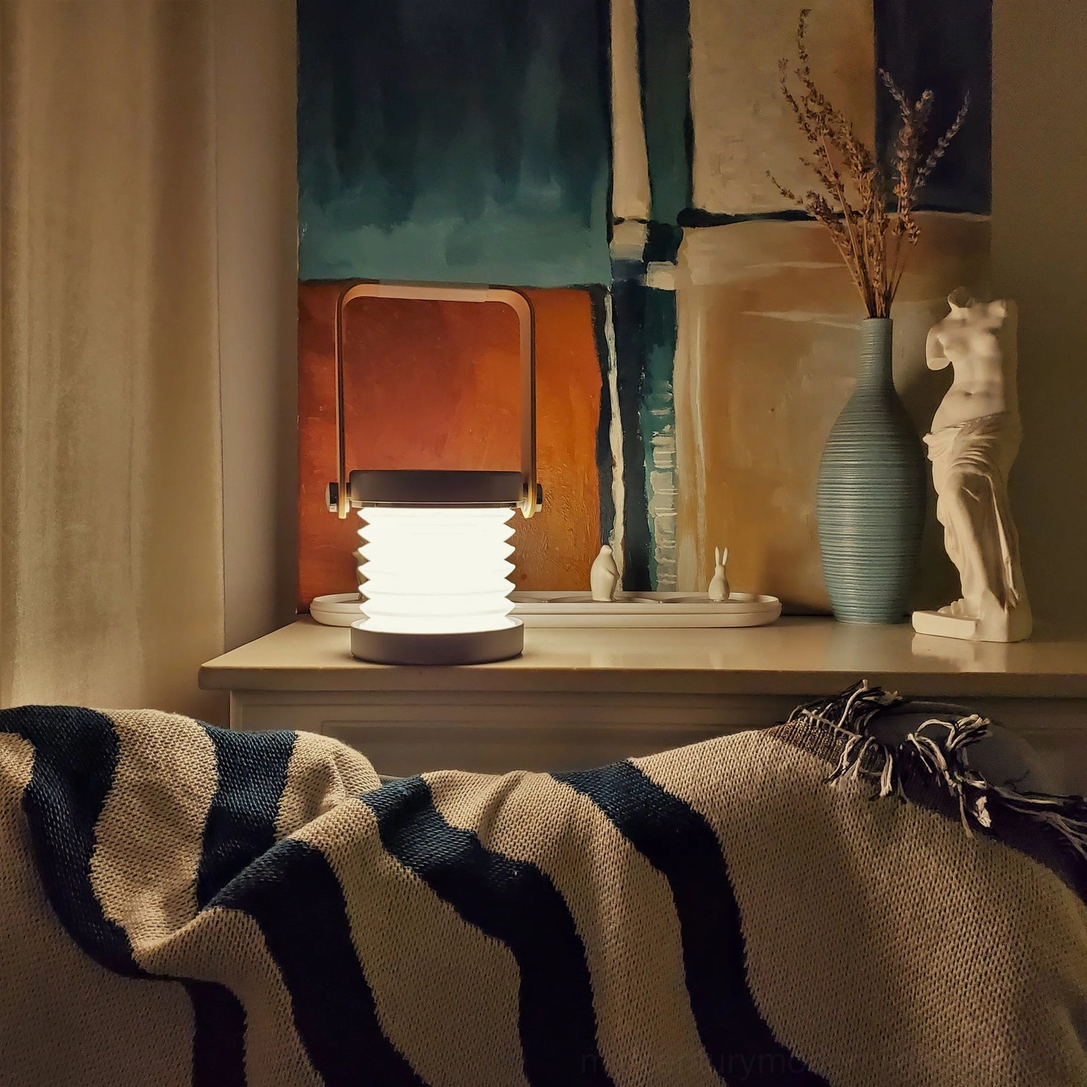 Portable honeycomb lantern lamp creating ambient glow on home art decor desk, warm LED light illuminating contemporary interior