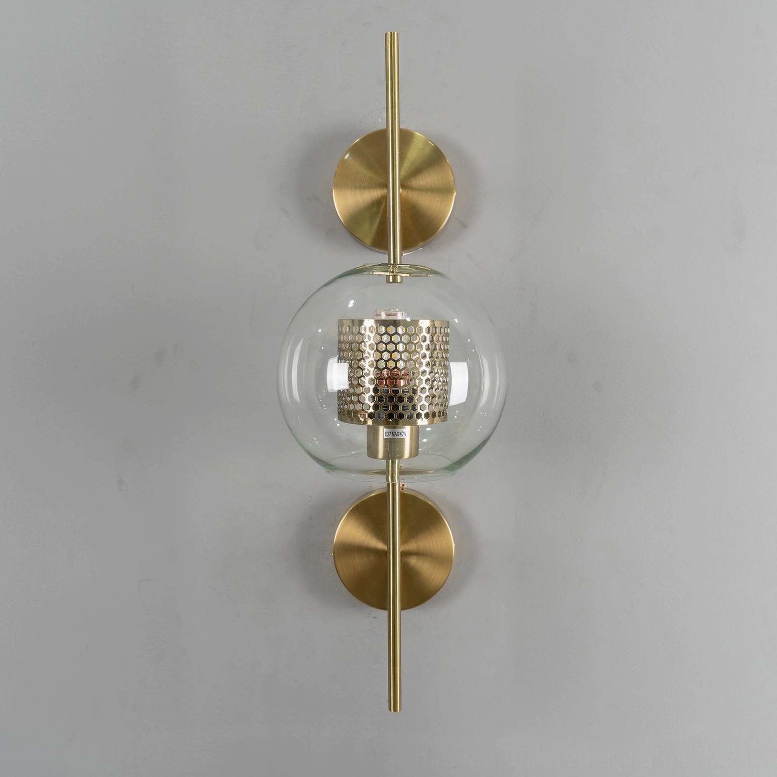 Honeycomb glass wall sconce detail showing mesh pattern and light diffusion
