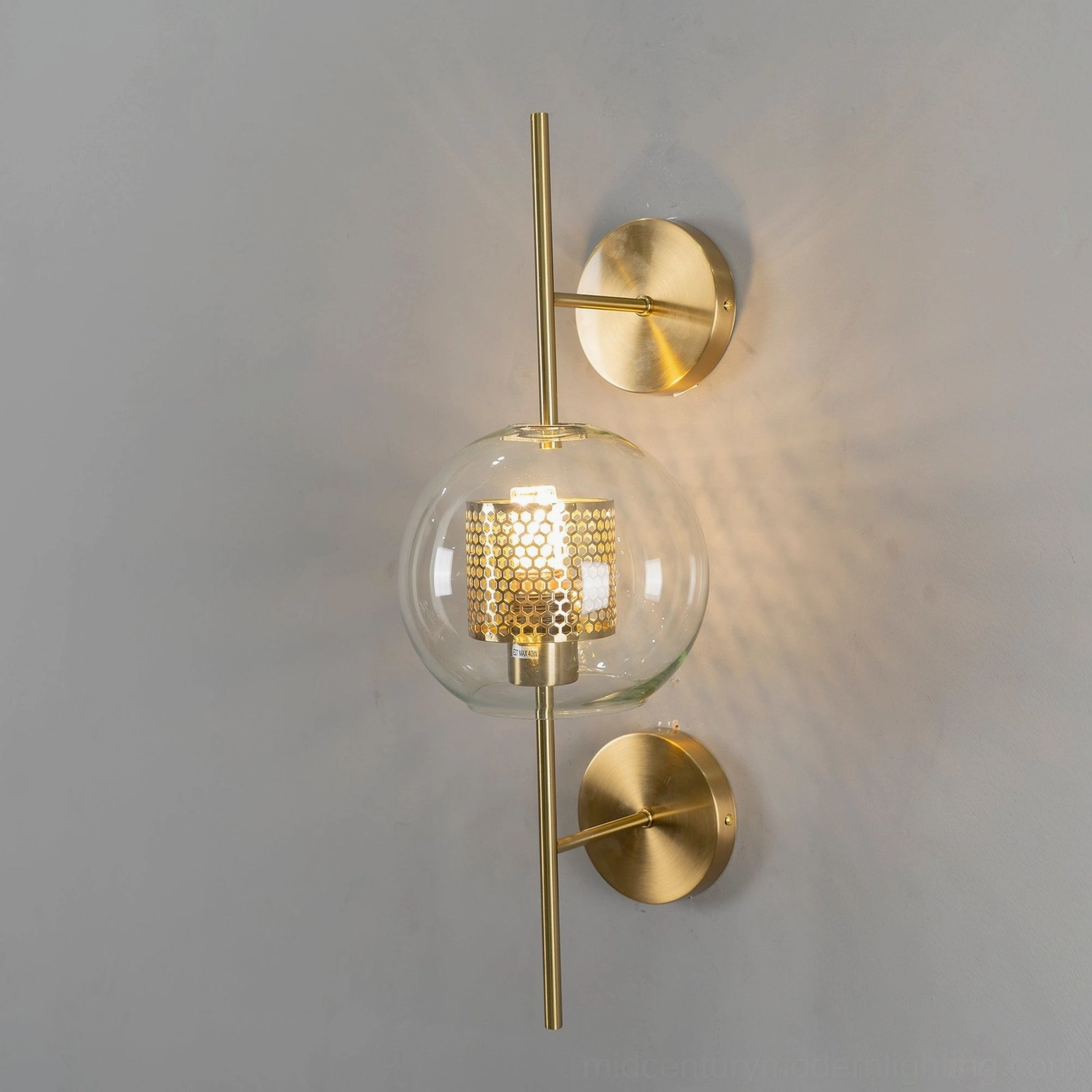Glass sconce showing honeycomb pattern and light diffusion in modern interior
