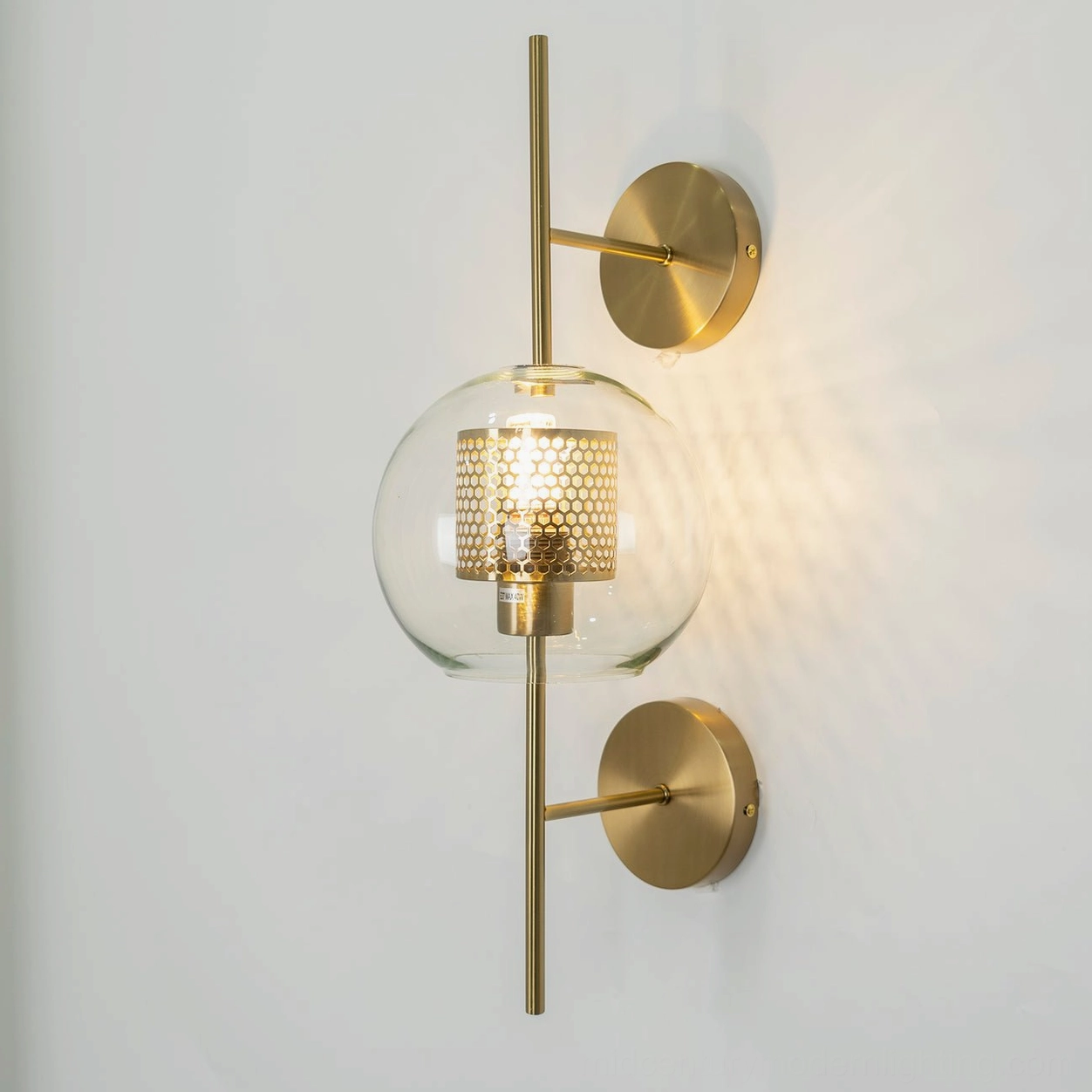 Contemporary honeycomb glass sconce detail showing light refraction and warmth