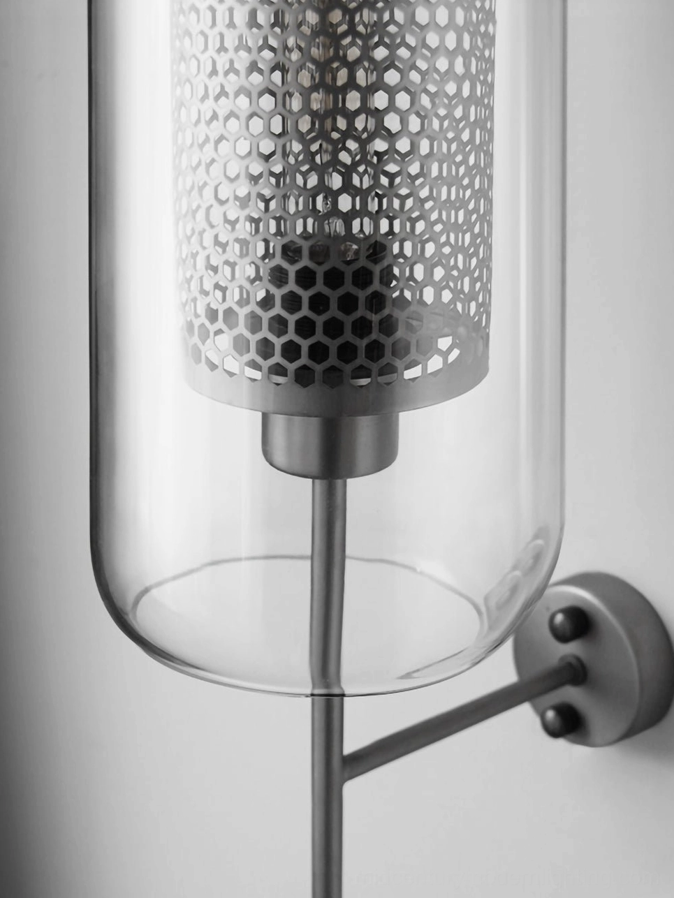 Honeycomb glass wall sconce with warm glow and ambient lighting capability