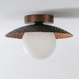 Close-up detail of Hooper flush-mount lamp showing hammered metal texture and copper inner finish of the acrylic diffuser
