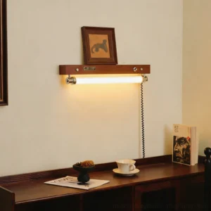 Hopper plug-in wall sconce mounted above desk with warm LED light illuminating workspace and framed artwork
