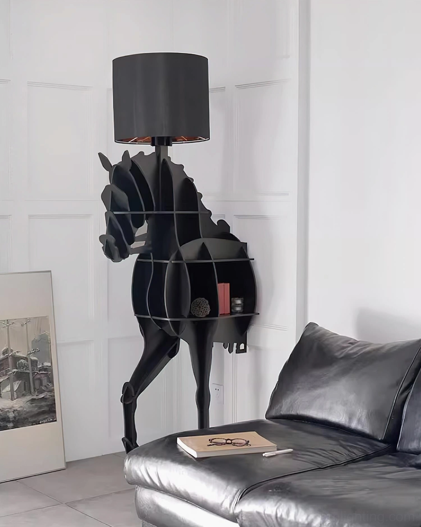 Sculptural horse lamp with integrated shelf beside leather sofa in contemporary living room, side profile view