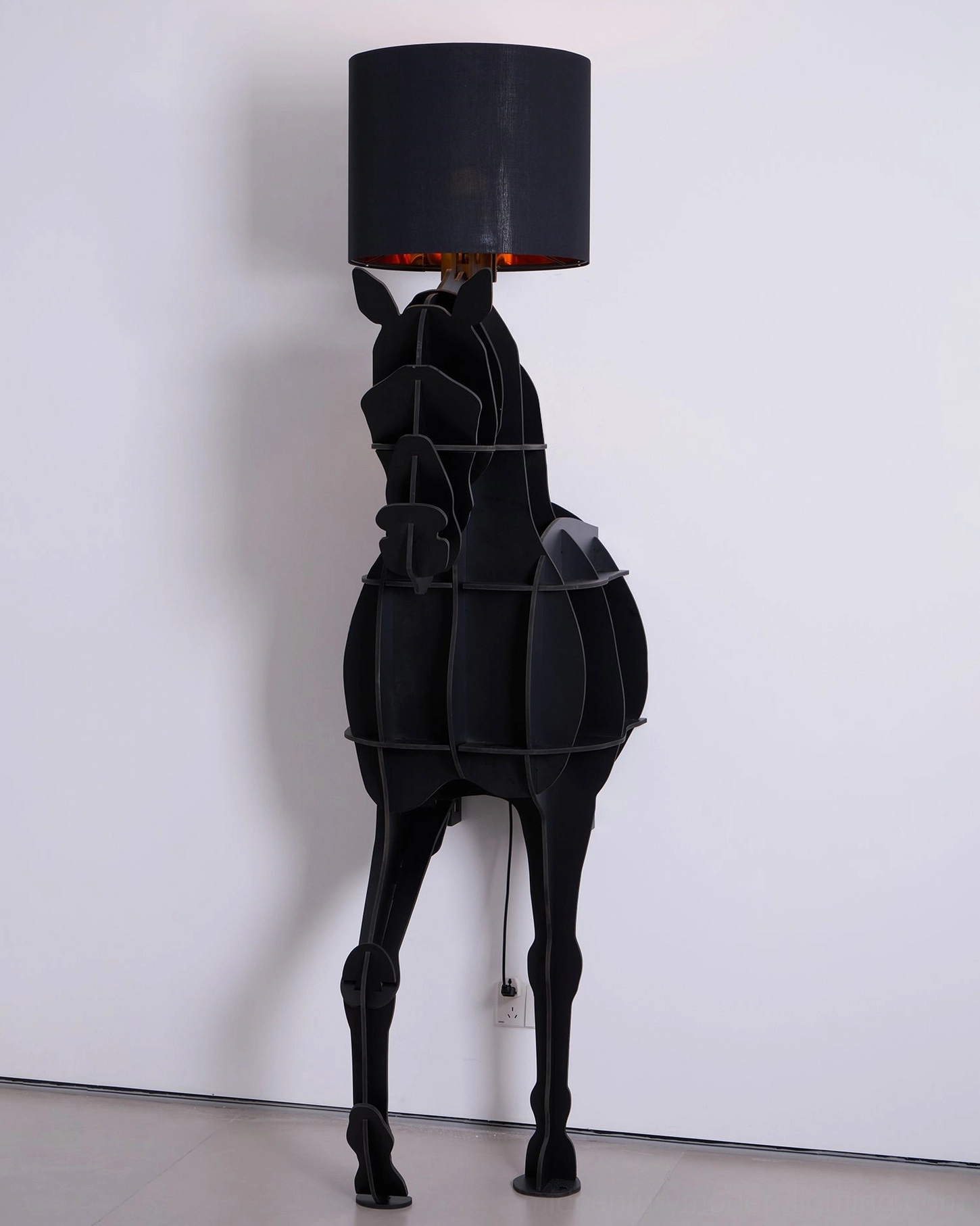 Horse floor lamp with storage shelf in contemporary interior, angled view of sculptural silhouette
