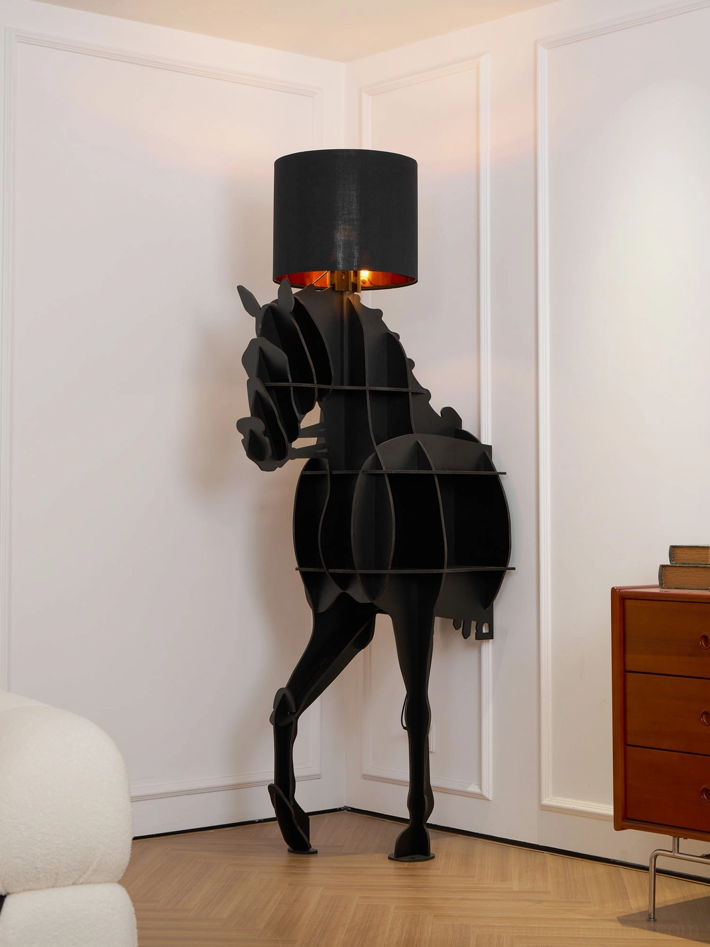 Sculptural horse floor lamp with black cylinder fabric shade against minimalist white wall, frontal side view