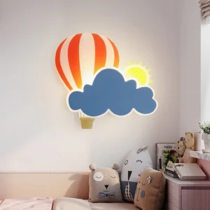 Hot air balloon wall lamp with sun and cloud accents displayed in warm kids bedroom - eye level view showing cozy ambiance